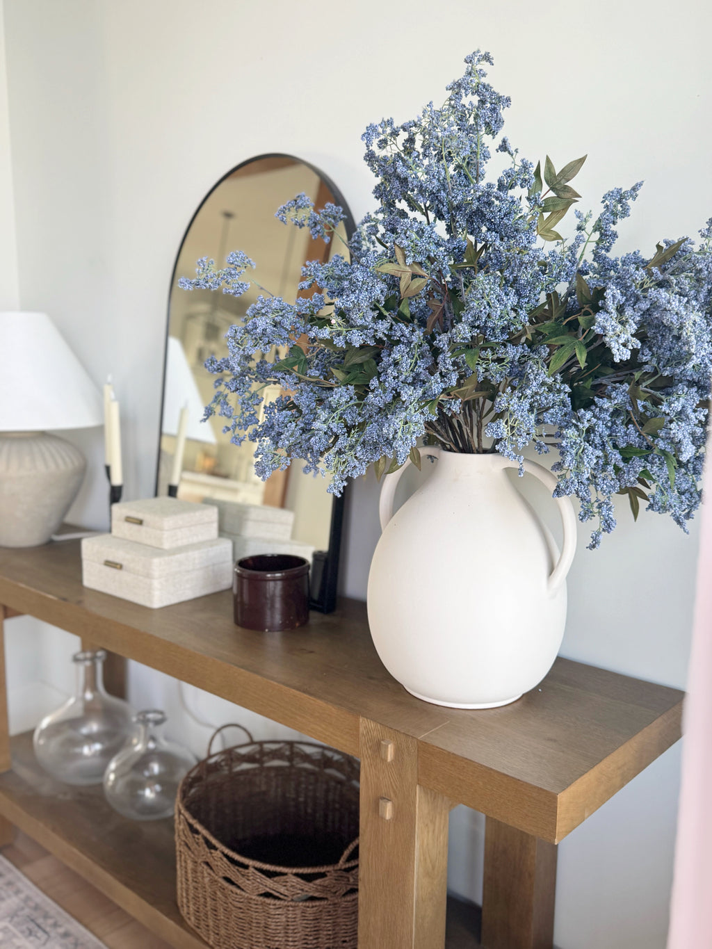 artificial plum berry branches in blue styled in the Afloral jug vase