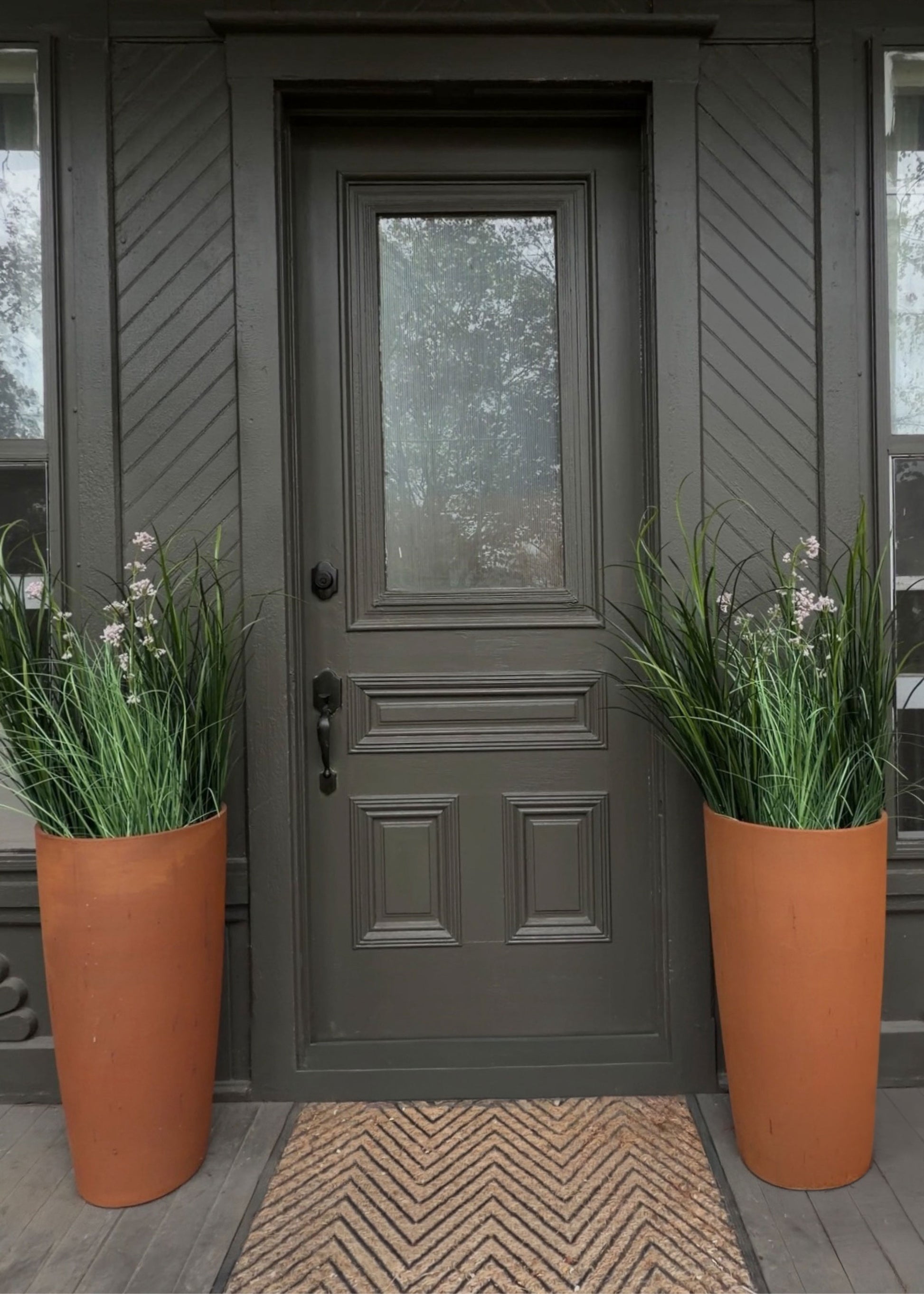 Front door with two potted Milkweed grass plants