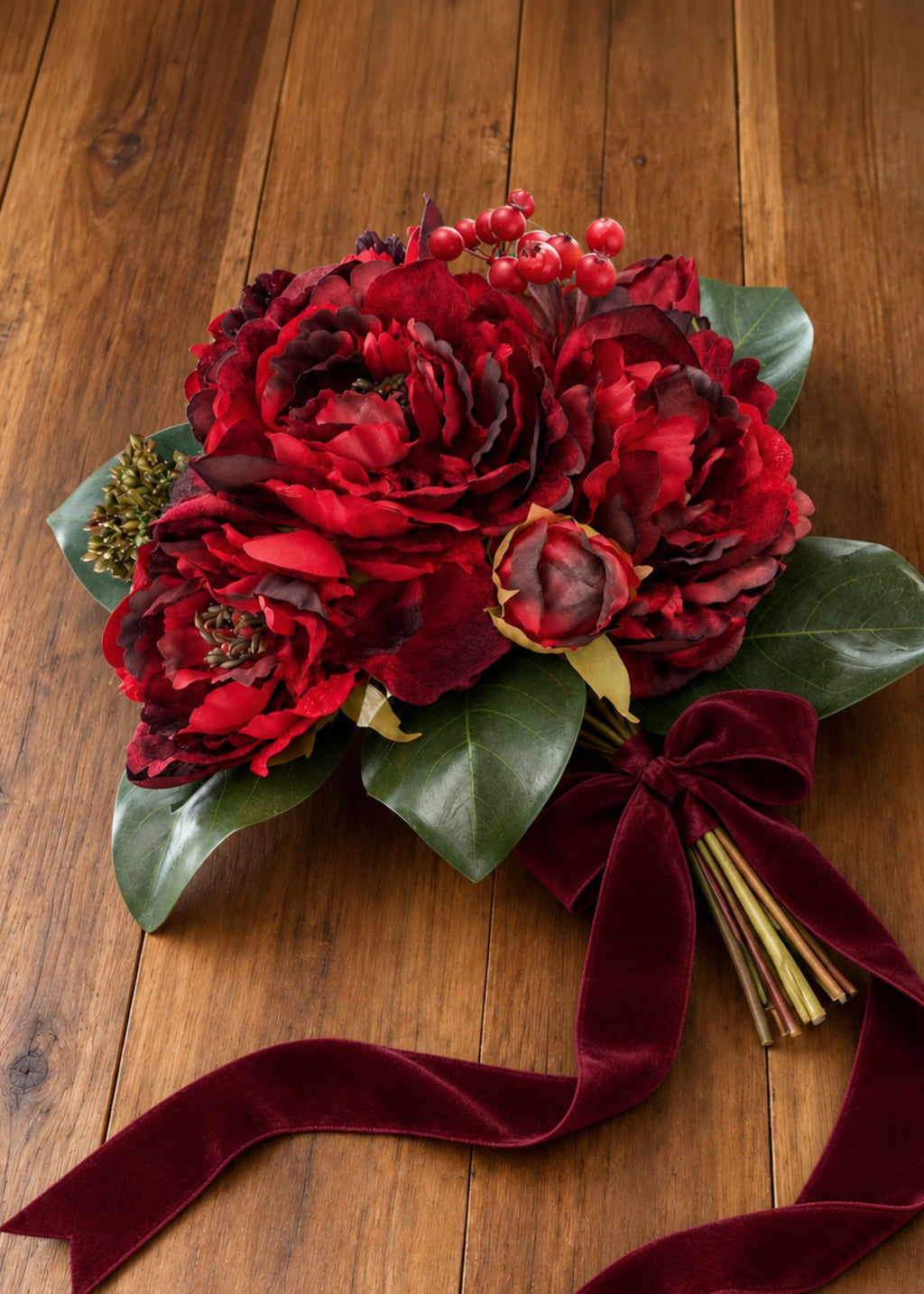 burgundy peony bouquet laying on a table