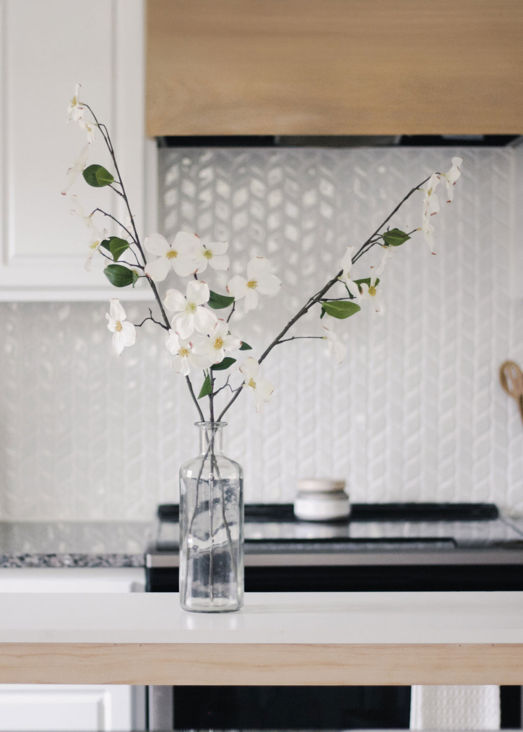 faux dogwood flowers in a vase