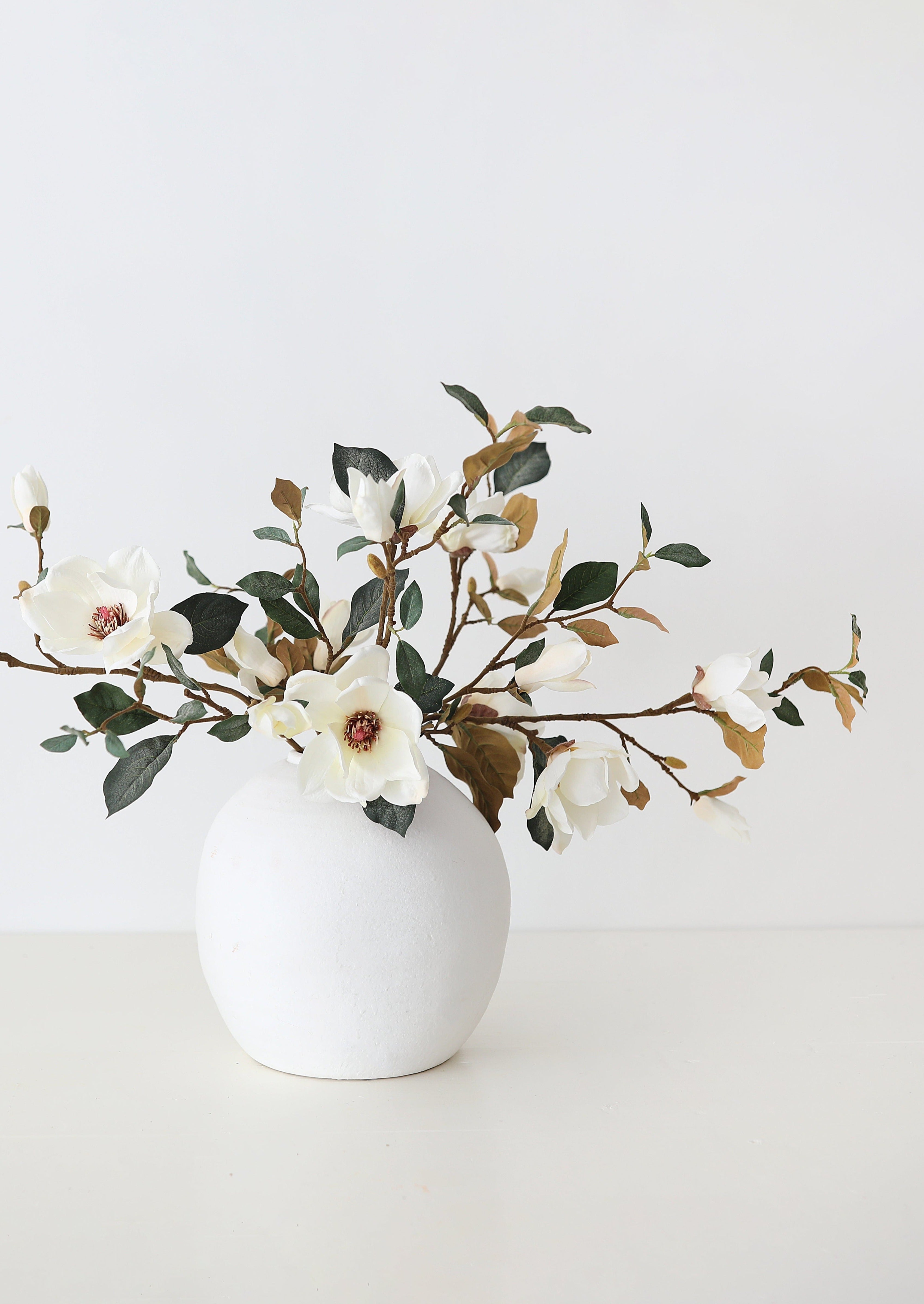White Konos Vase Styled with Faux Magnolia Branches