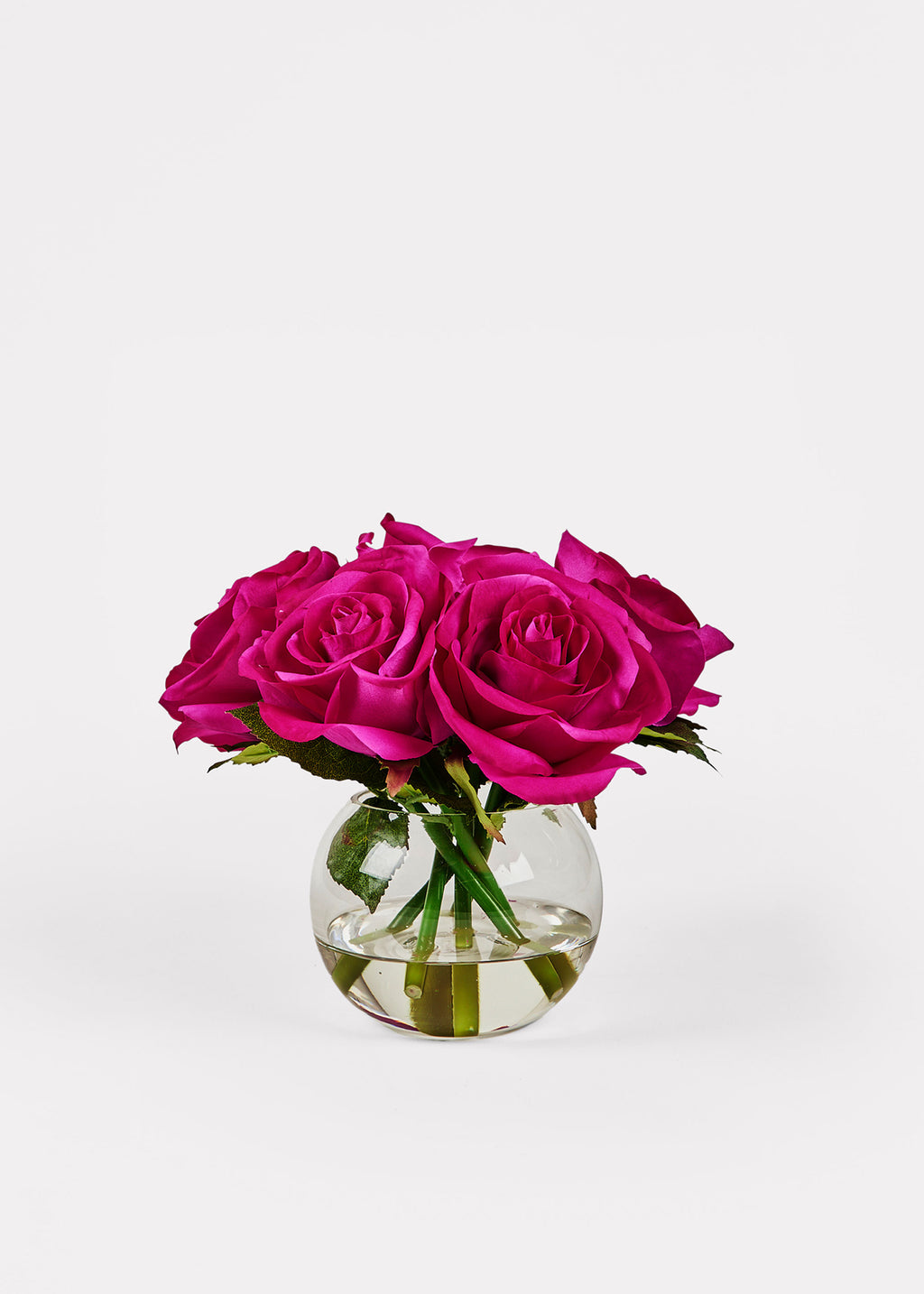 small faux arrangement of fuchsia real touch roses in round glass vase at 