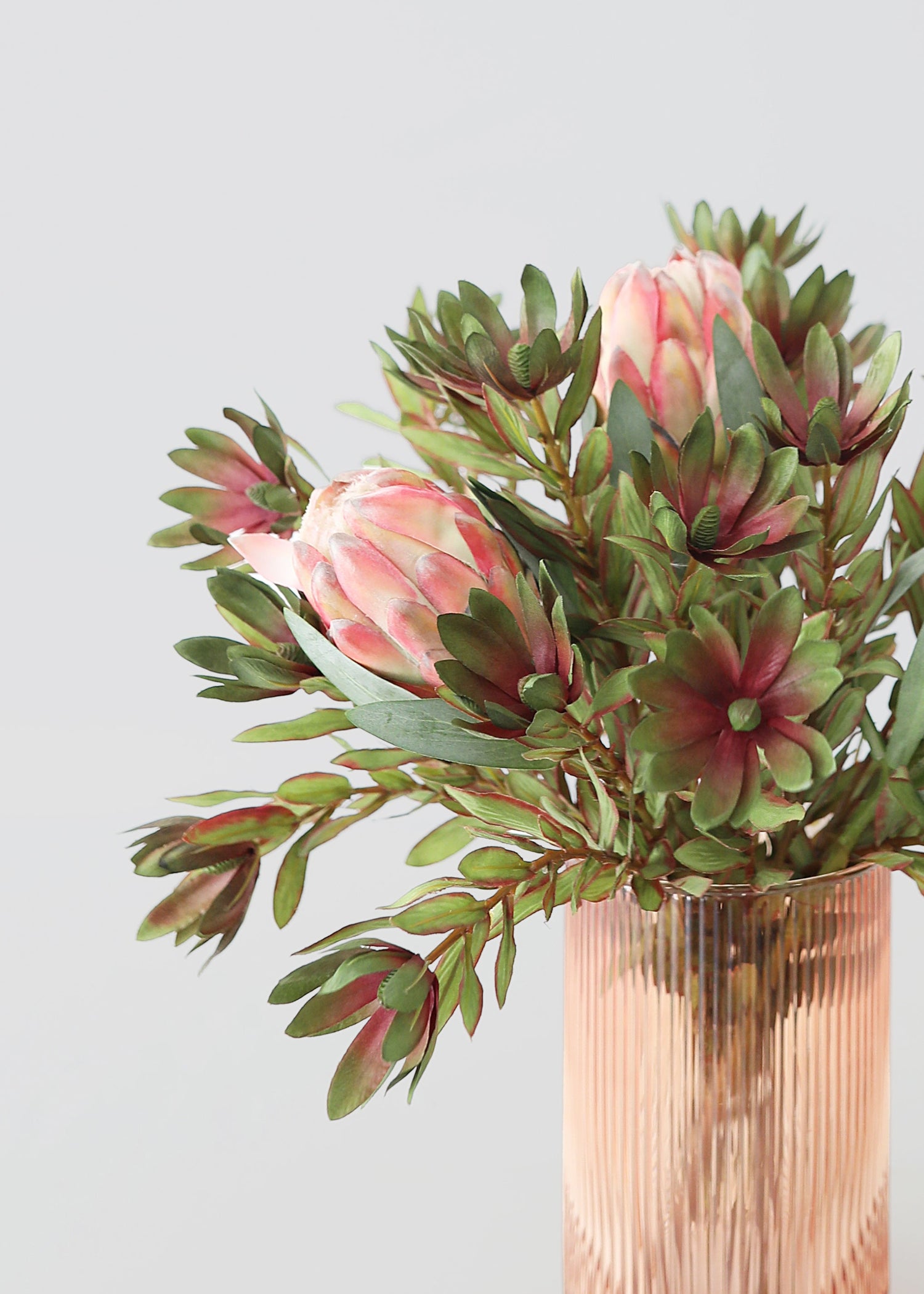 Bouquet of pink protea flowers an greenery 