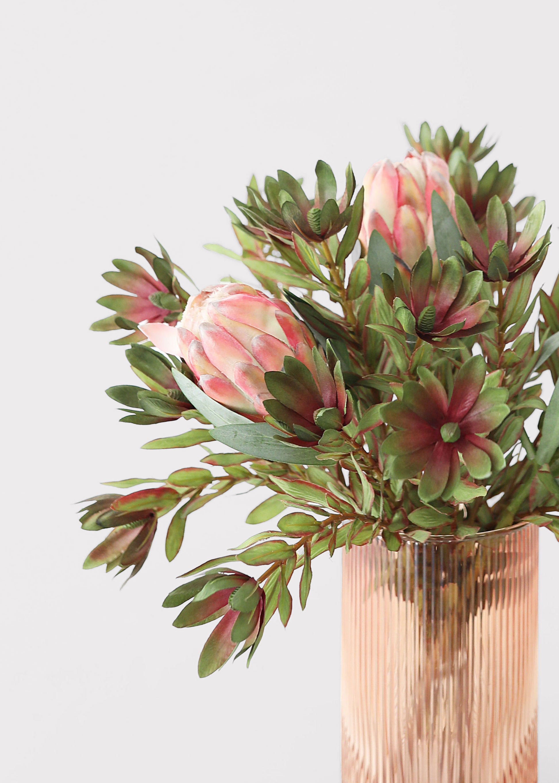 Bouquet of pink protea flowers an greenery 