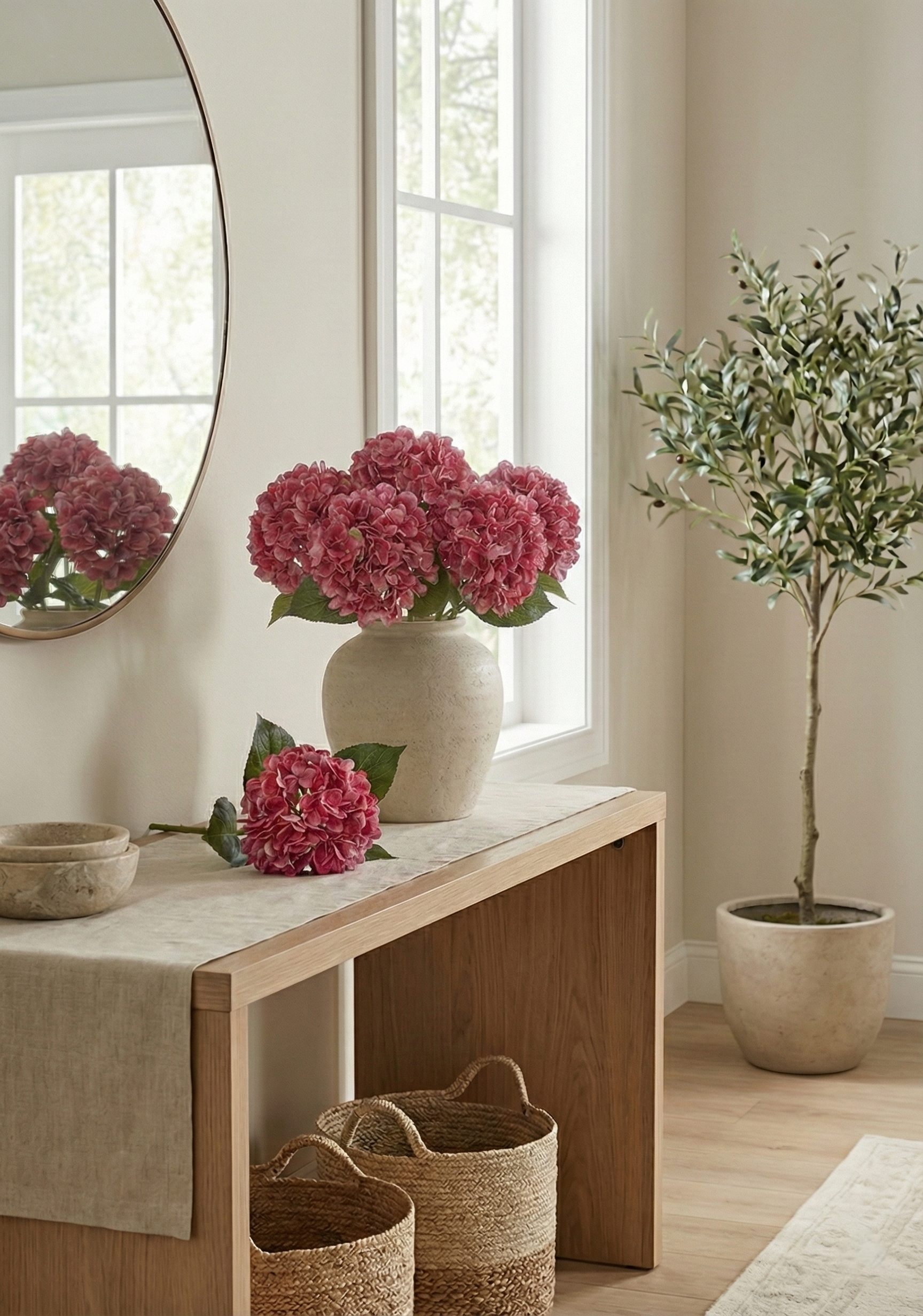 Nest living room with a wooden bench, pink flowers in a vase, and a plant.