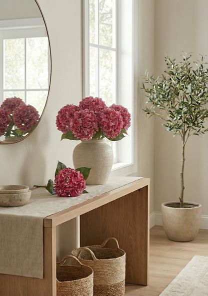 Nest living room with a wooden bench, pink flowers in a vase, and a plant.