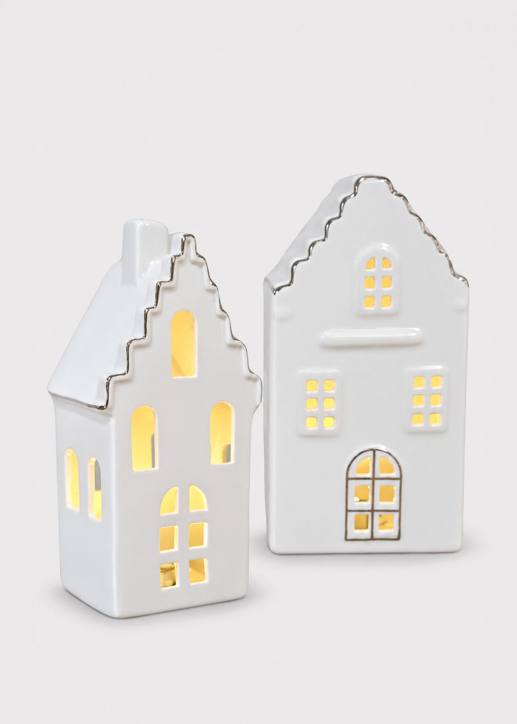 white ceramic houses with candle lit windows