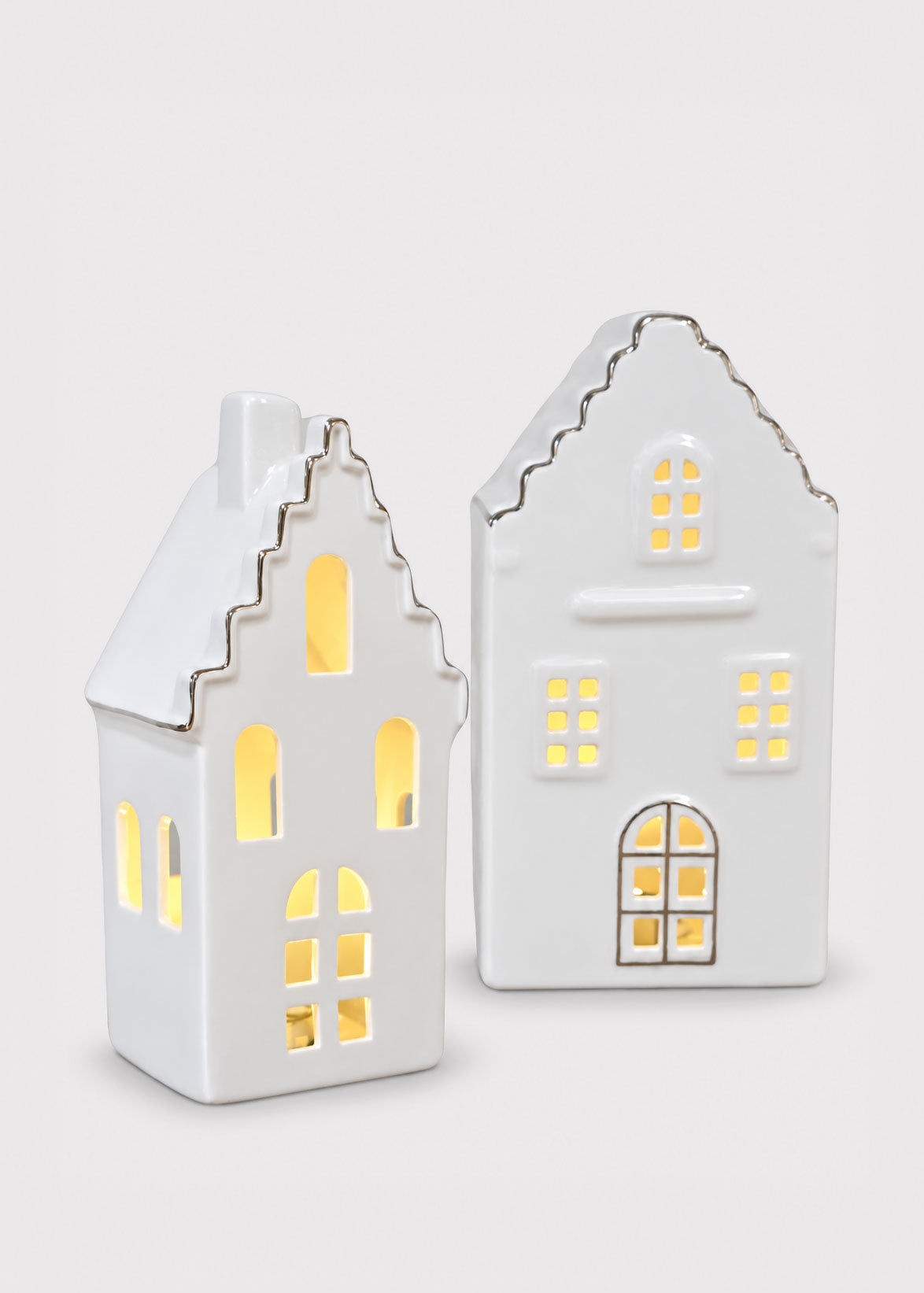 white ceramic houses with candle lit windows