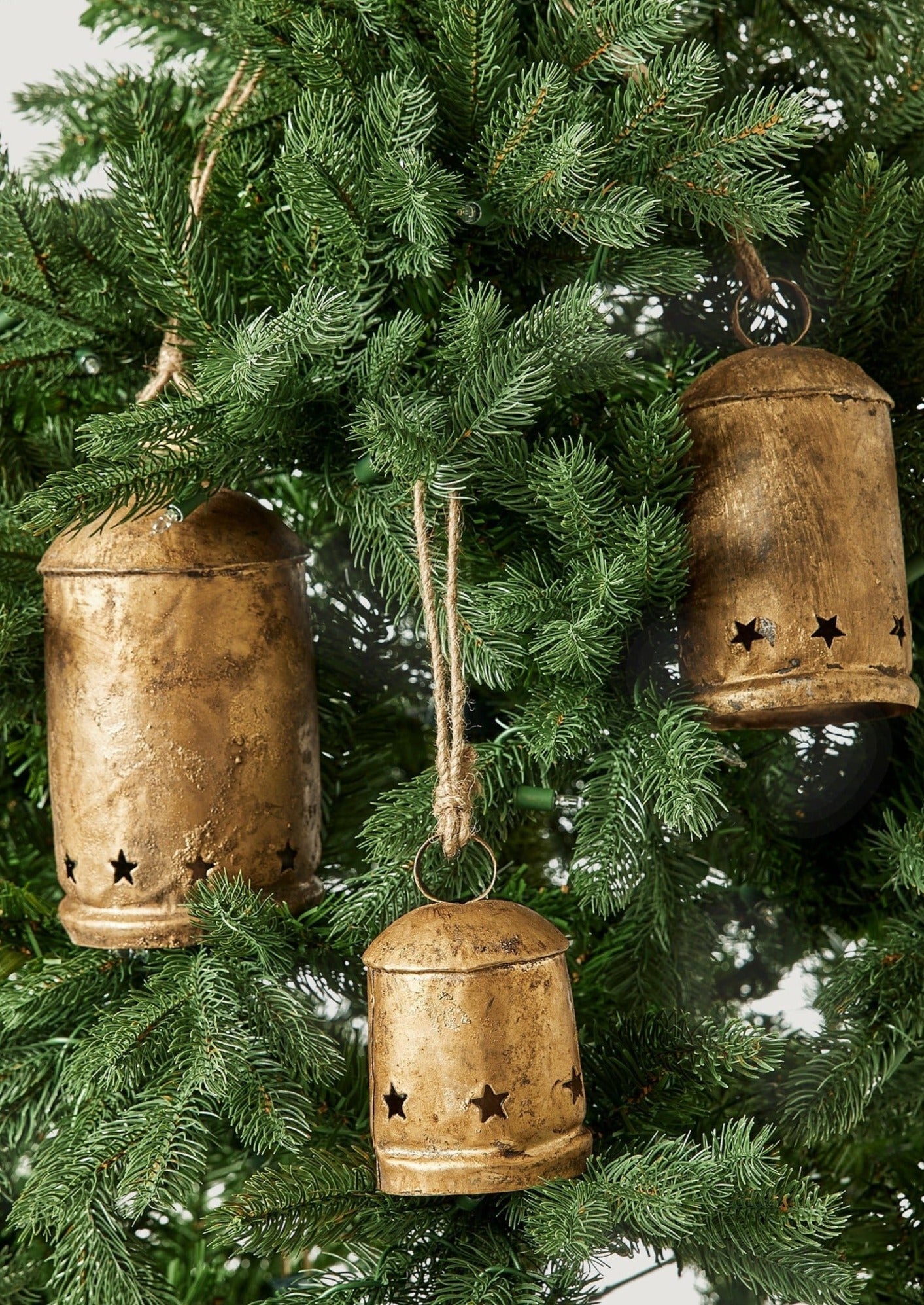 Antique Gold Metal Bell Ornaments on Artificial Christmas Tree at Afloral