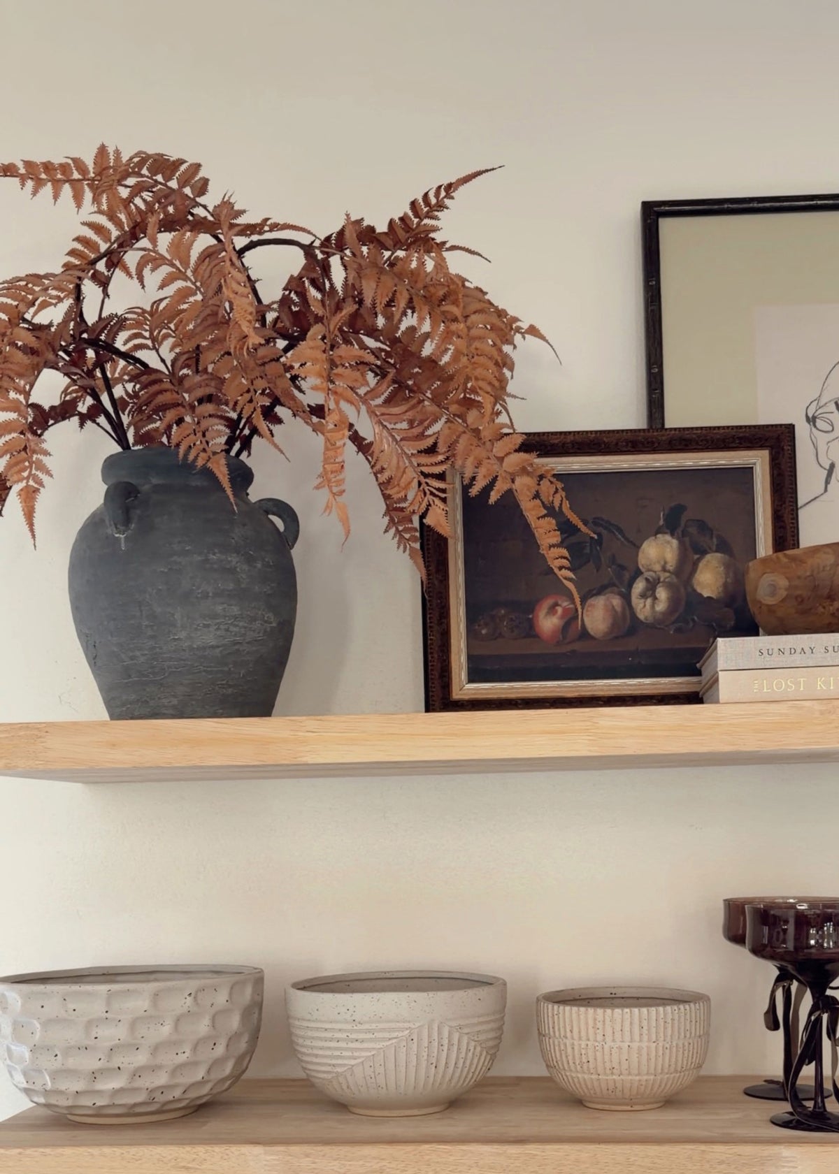 fall ferns arranged in a vase on a shelf