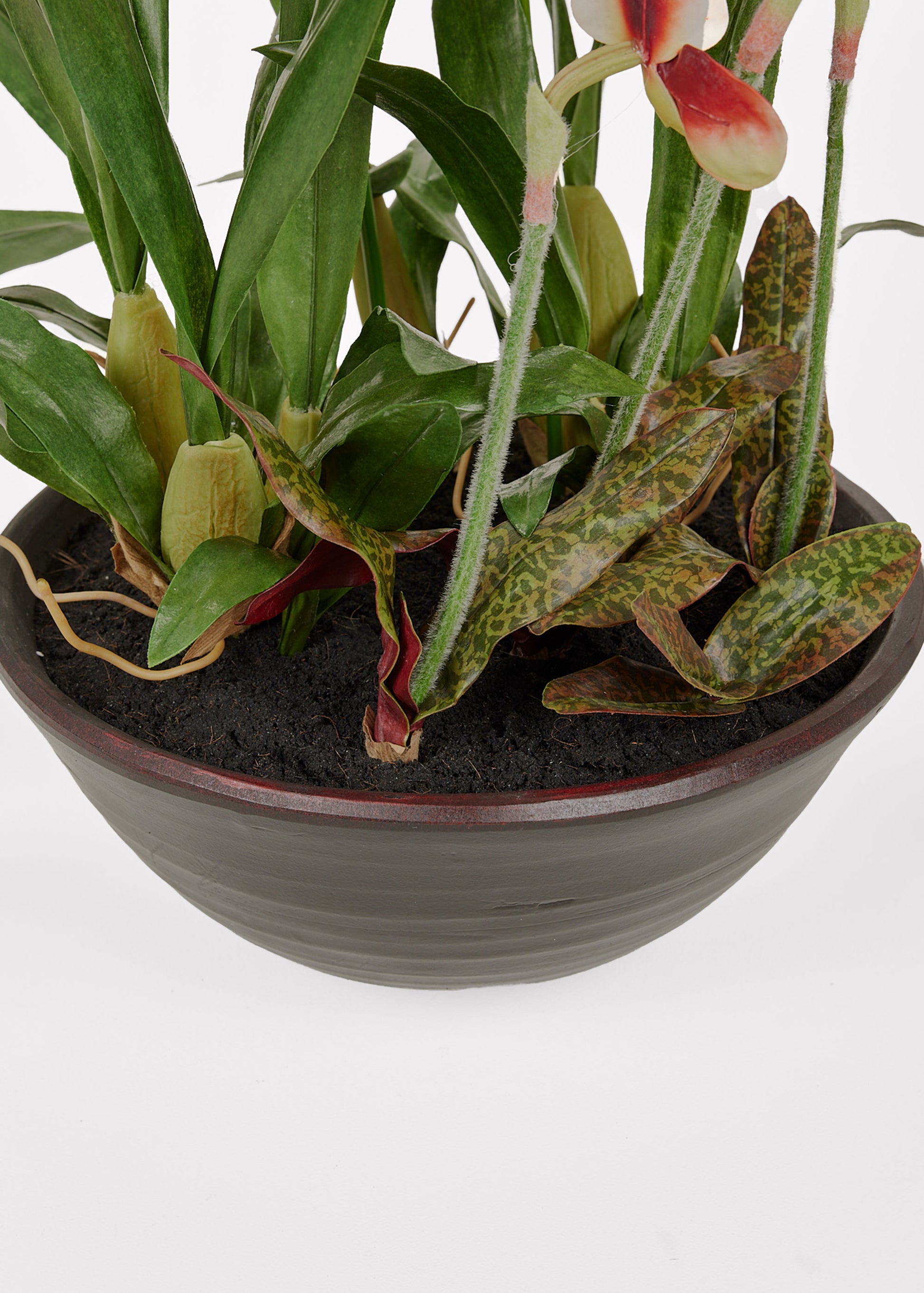 Potted plant with artificial soil and green leaves