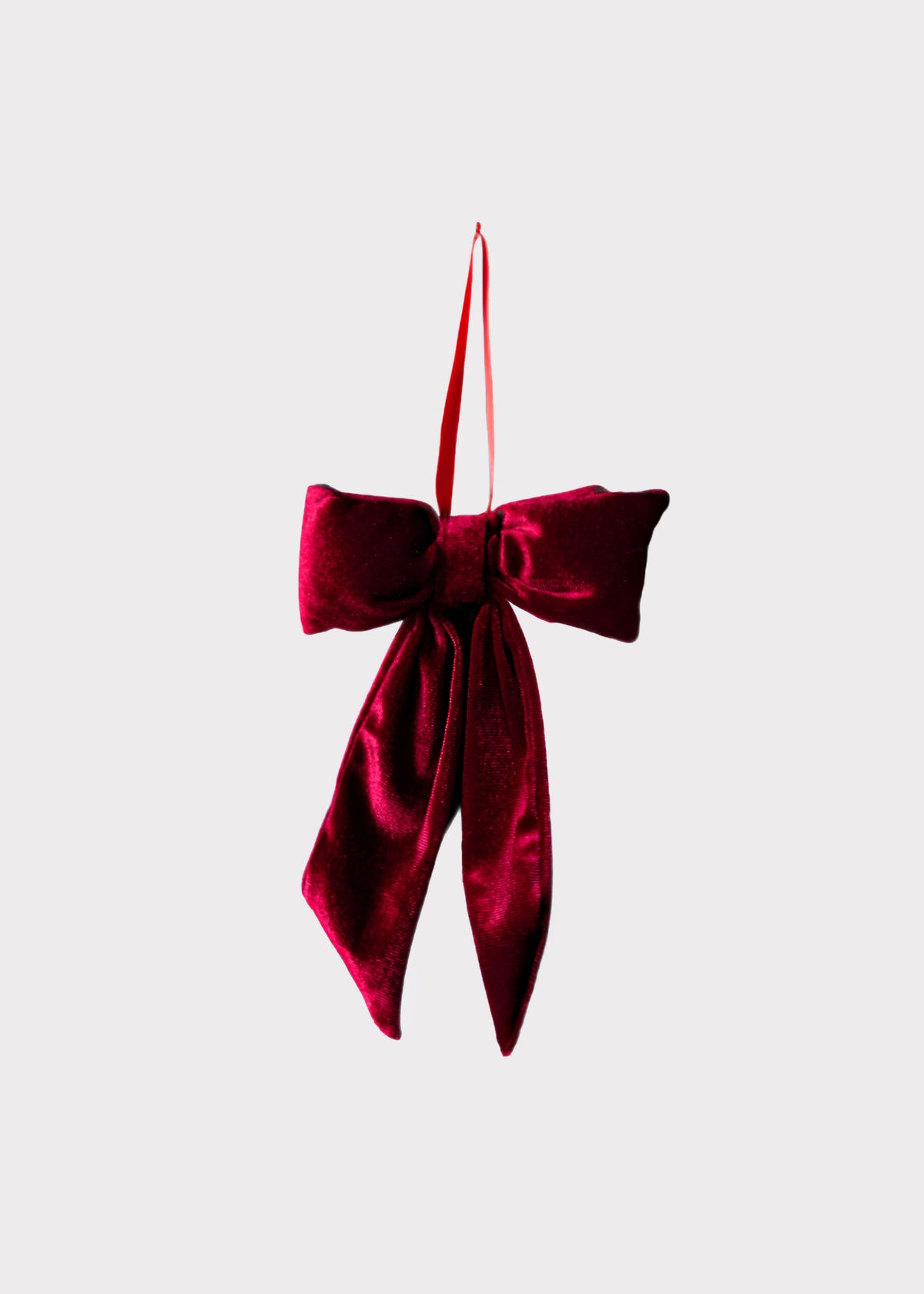 A deep burgundy velvet bow ornament with a hanging loop