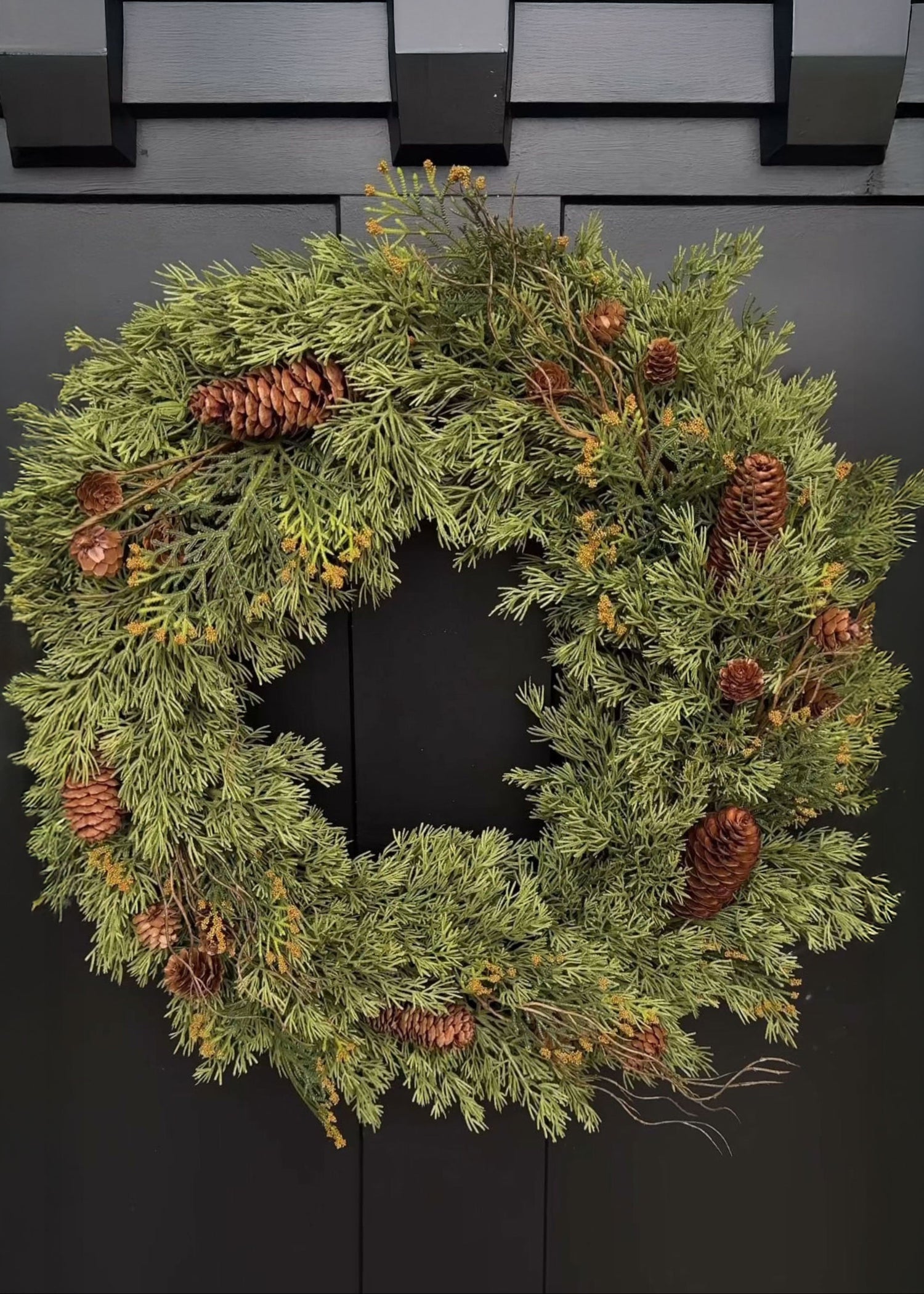 Evergreen wreath with pine cones