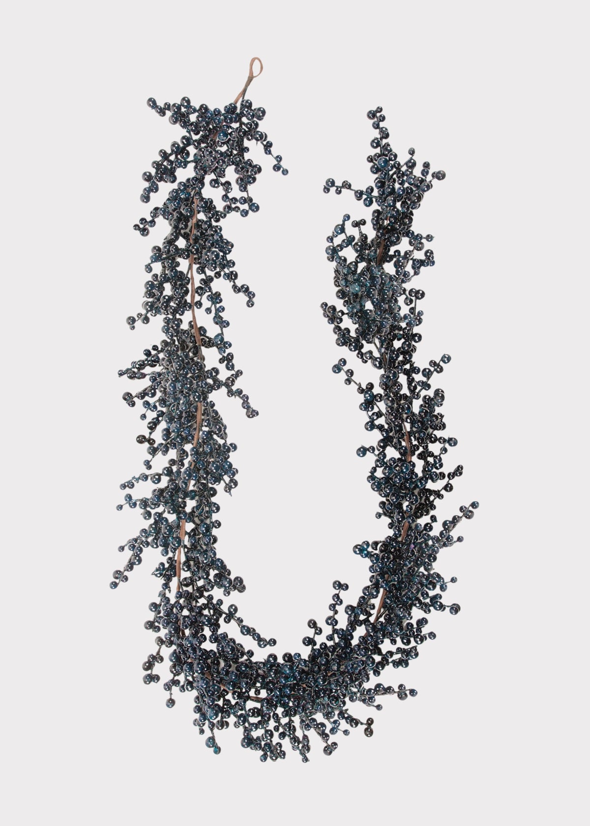 A hanging garland made of dark blue-gray berries on thin brown stem