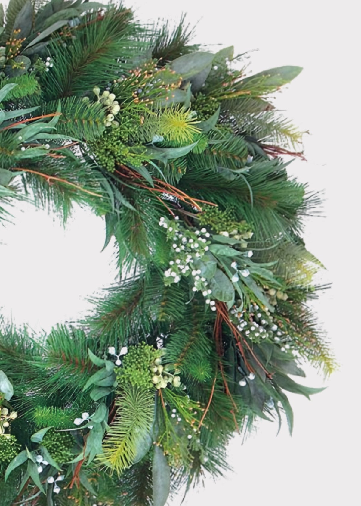 Close-up of a Fake Pine and Seeded Eucalyptus Holiday Greenery Wreath 