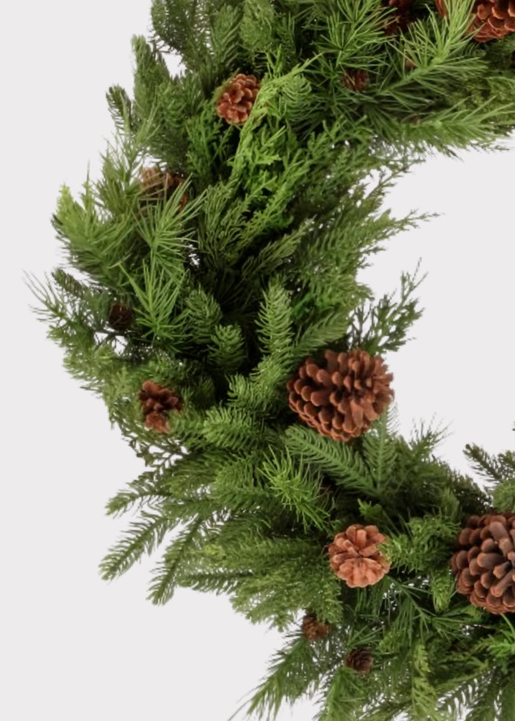 Close-up of a Natural Touch Fake Mixed Greenery and Pinecone Holiday Wreath