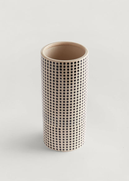 Cylindrical ceramic vase with a black dot pattern