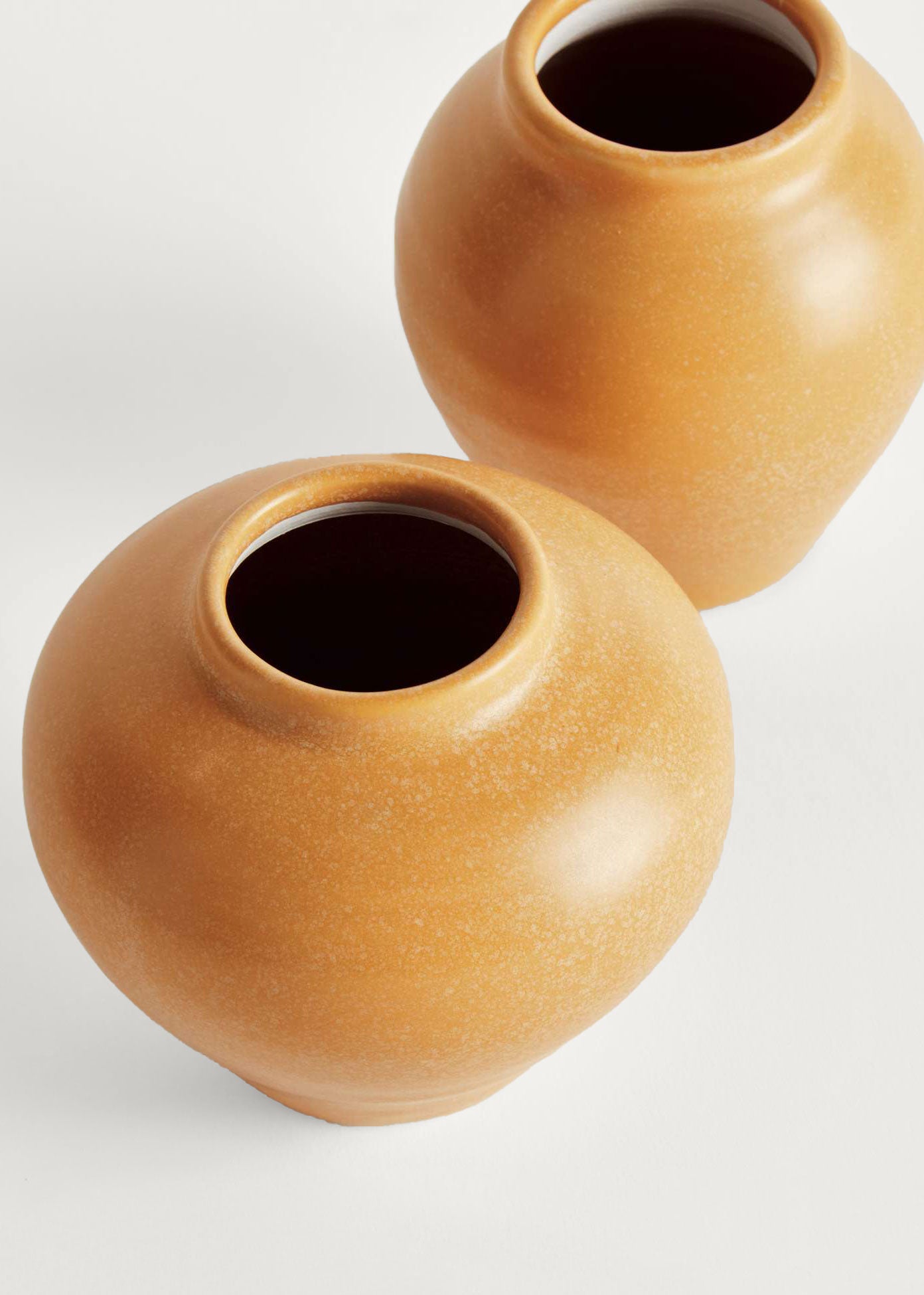 Two yellow ceramic pots