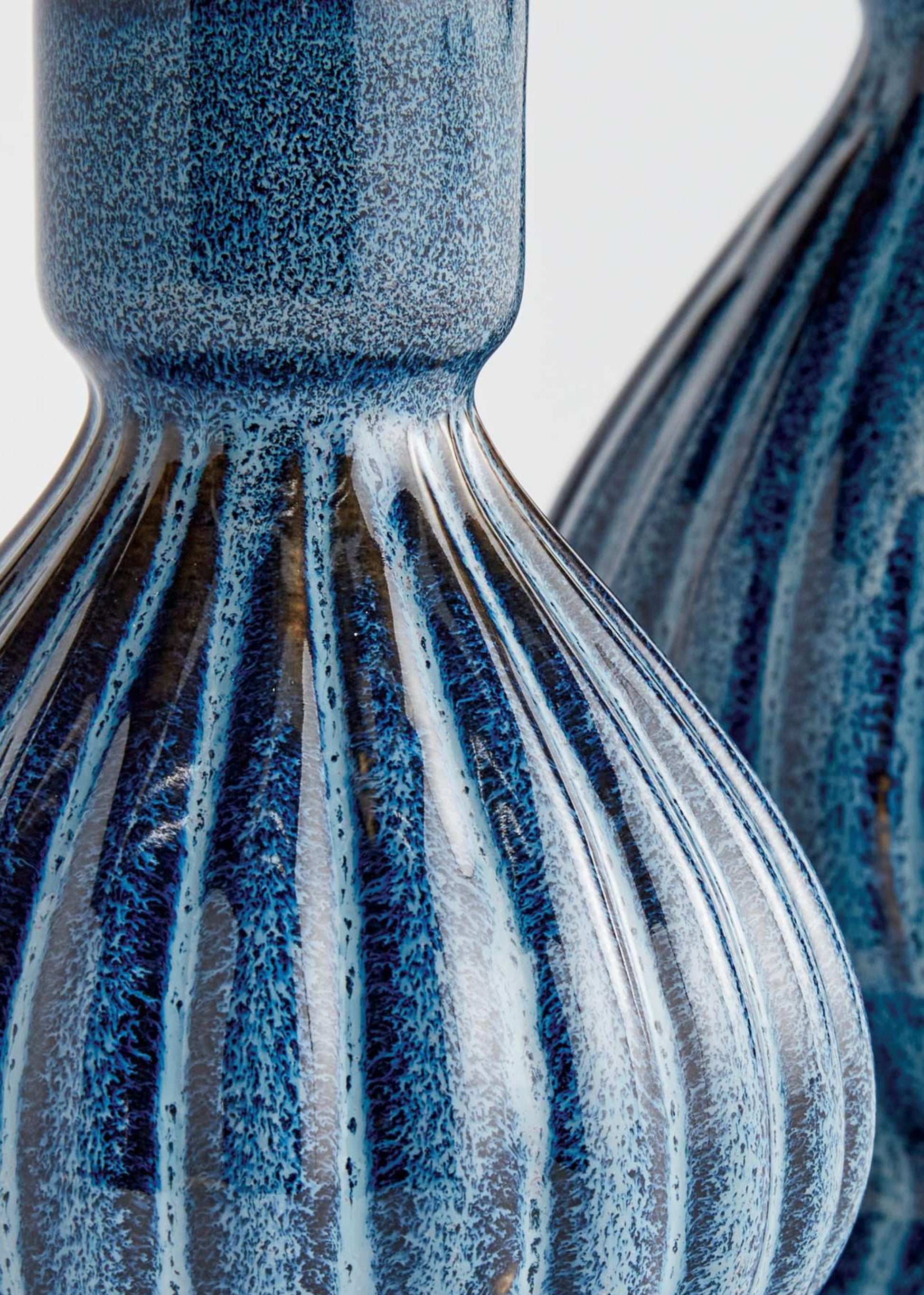Close-up of a blue stoneware candle holder
