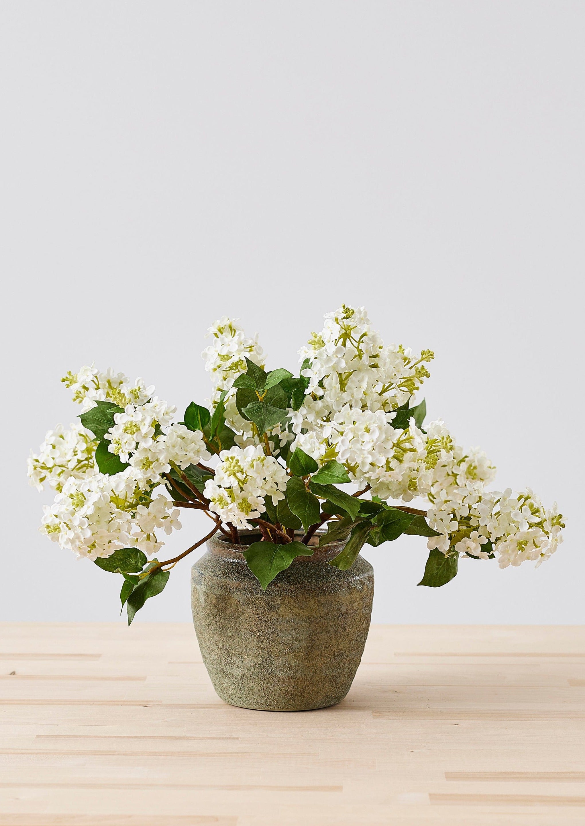 faux lilac flower arrangement designed with chicken wire