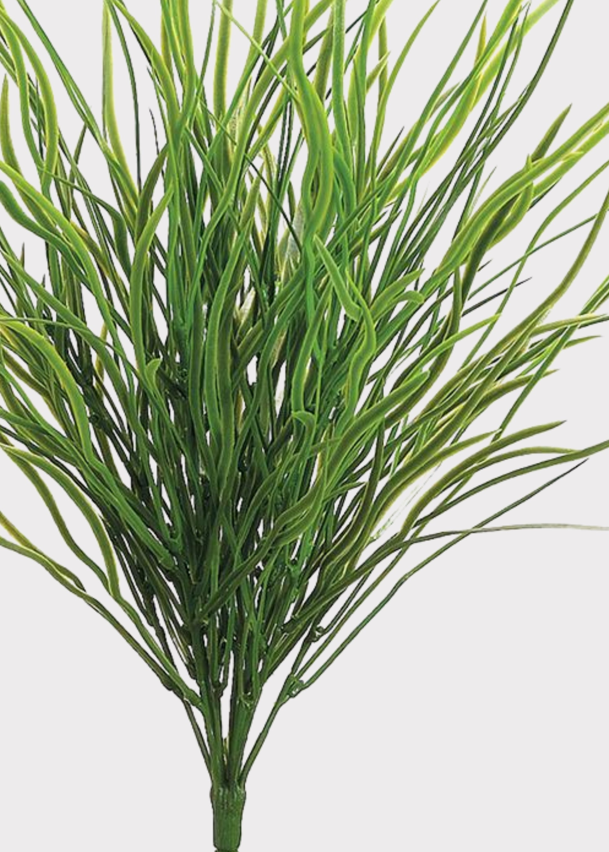 Artificial green grassy plant stem with long narrow leaves, isolated on a light gray background.