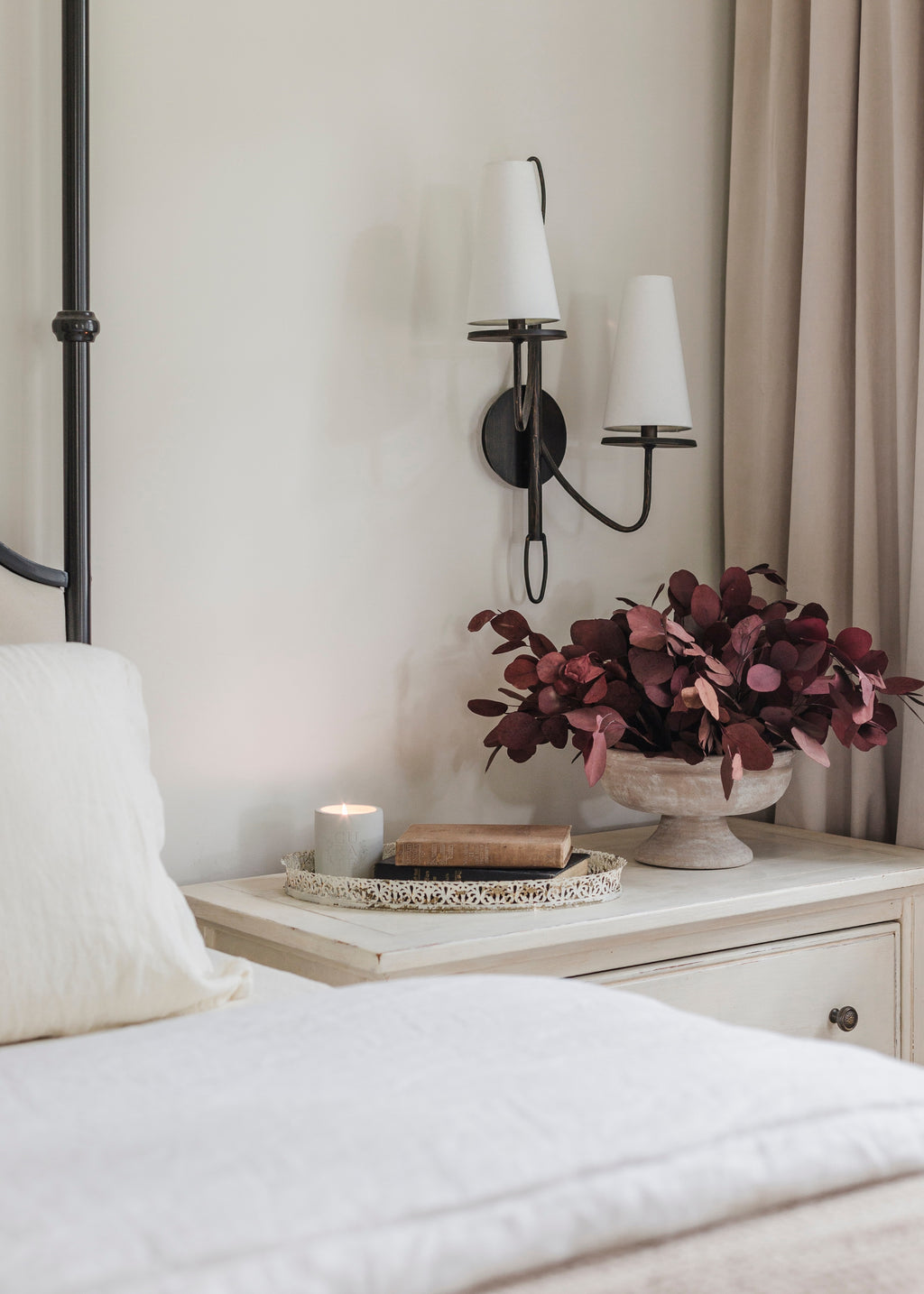 Decorative nightstand with a compote vase and eucalyptus