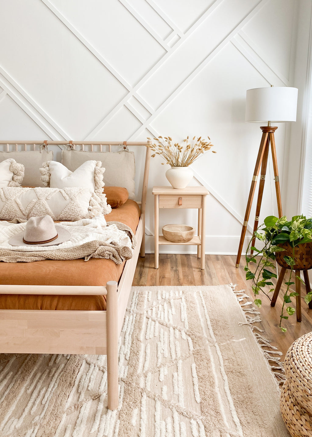 boho bedroom with dried bunnytails arranged on the nightstand
