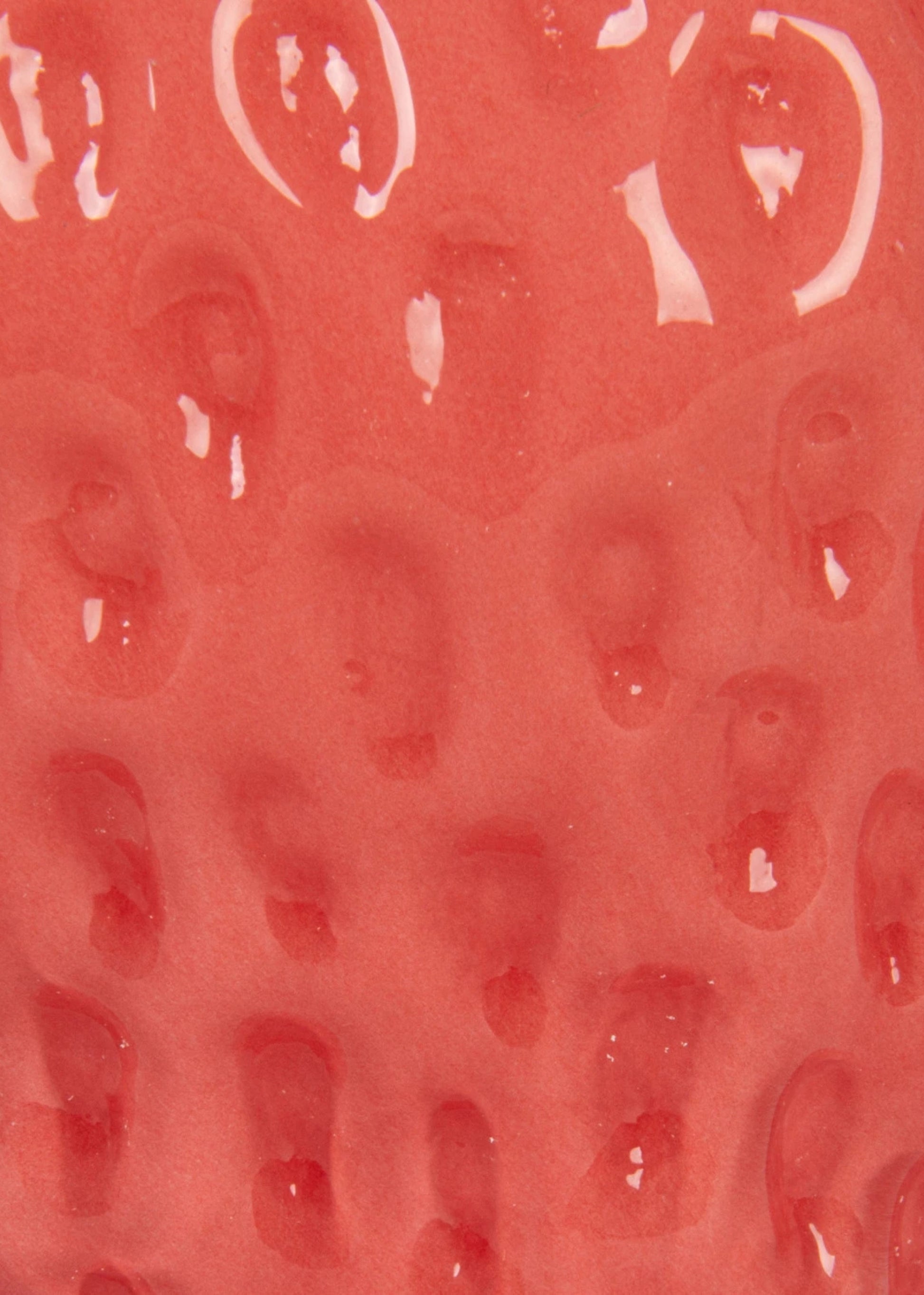 Red textured surface of glass strawberry vase