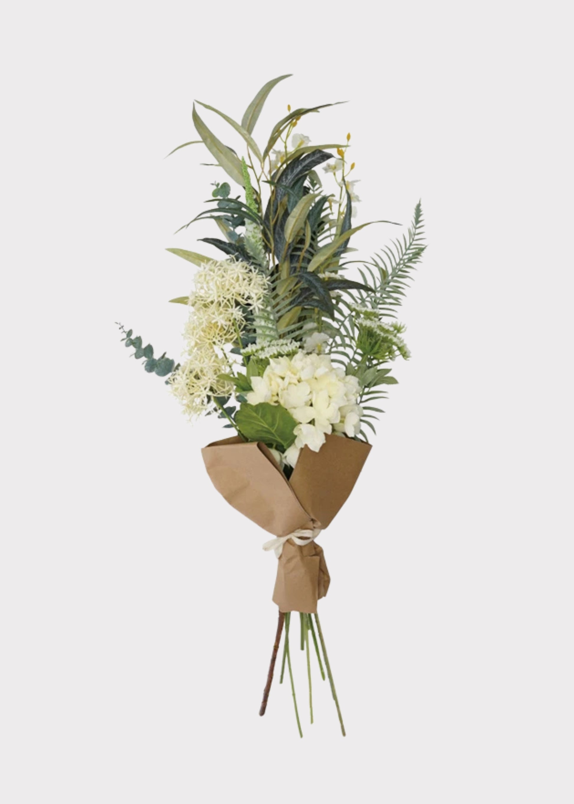 Bouquet of greenery and white flowers wrapped in brown paper 