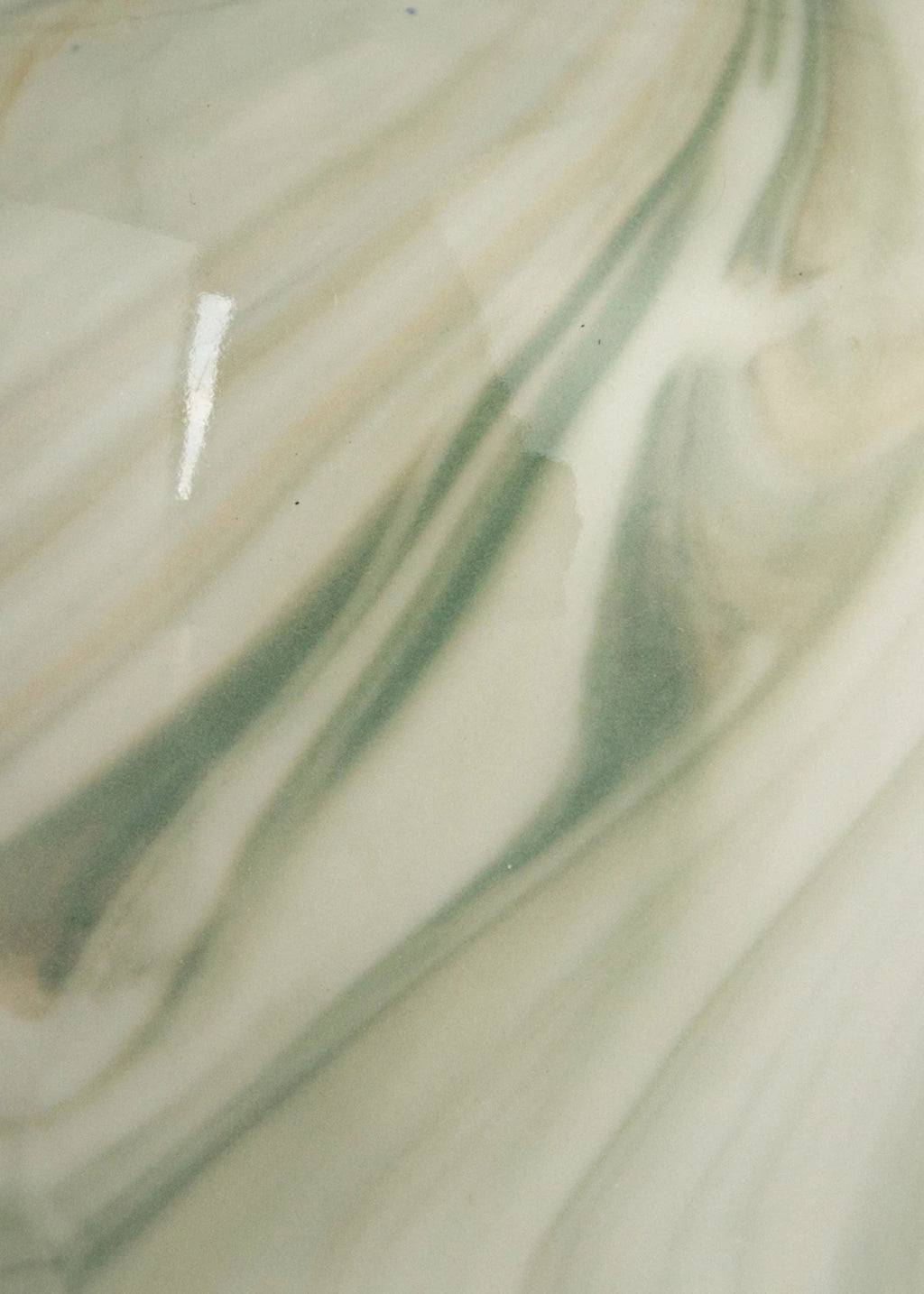 Close-up of a marbled surface with green and beige colors