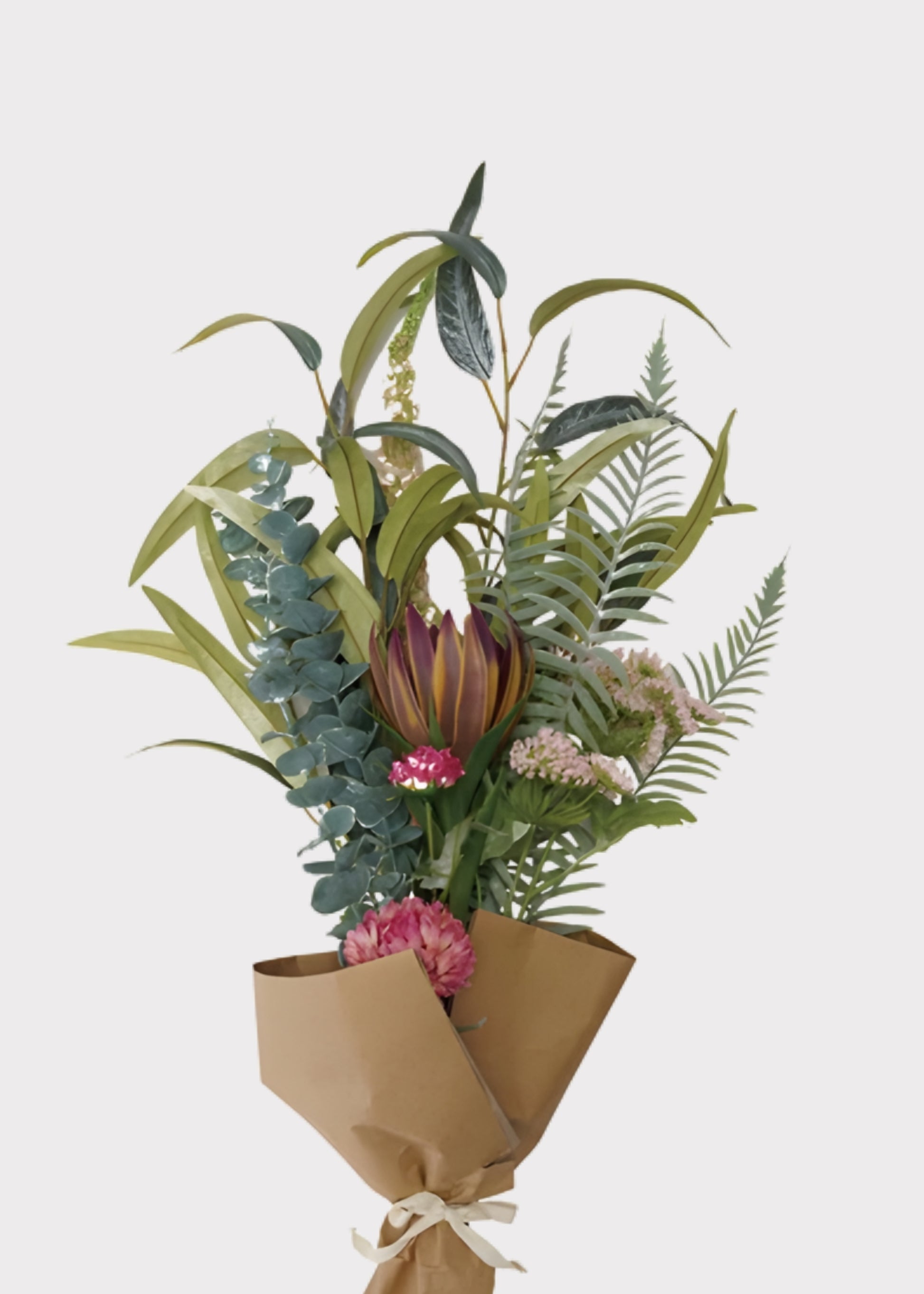 Bouquet of artificial plants and flowers wrapped in brown paper 