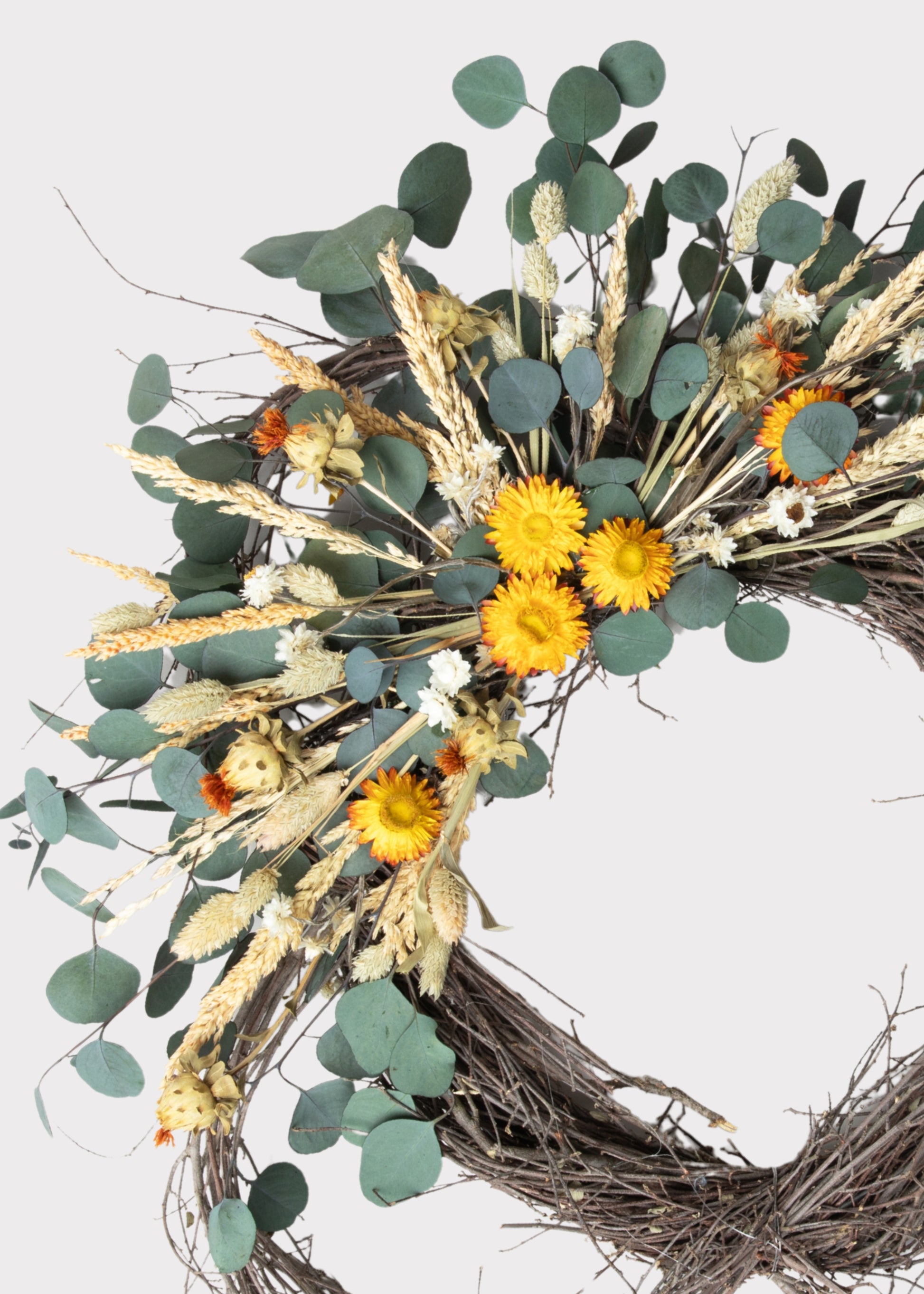 Close-up of the Green Dried Foliage and Orange Mixed Flower Wreath