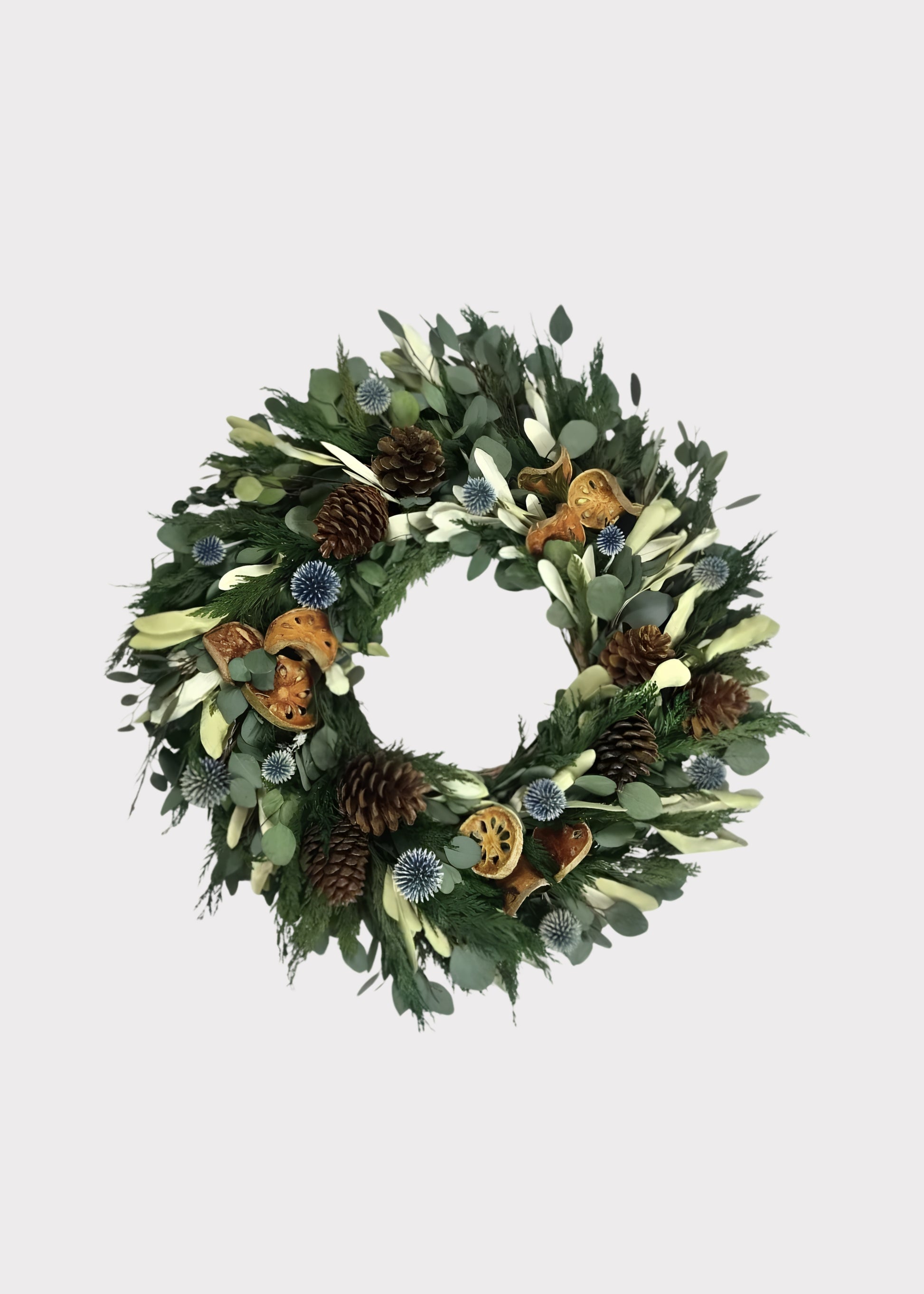 Decorative wreath with greenery, pinecones, and autumn-themed elements 