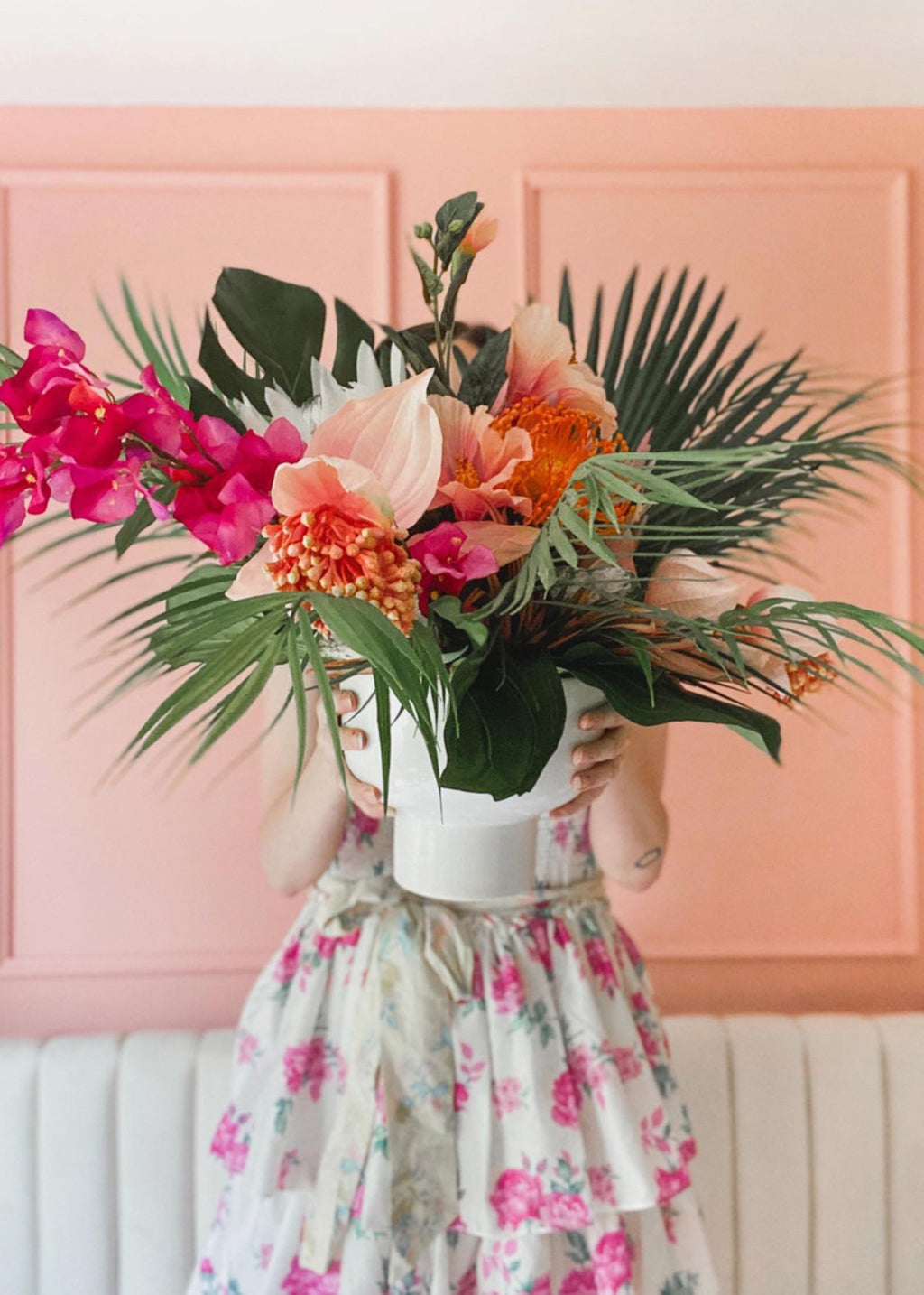 tropical flower arrangment with hibiscus, palms, bougainvillea, and monstera