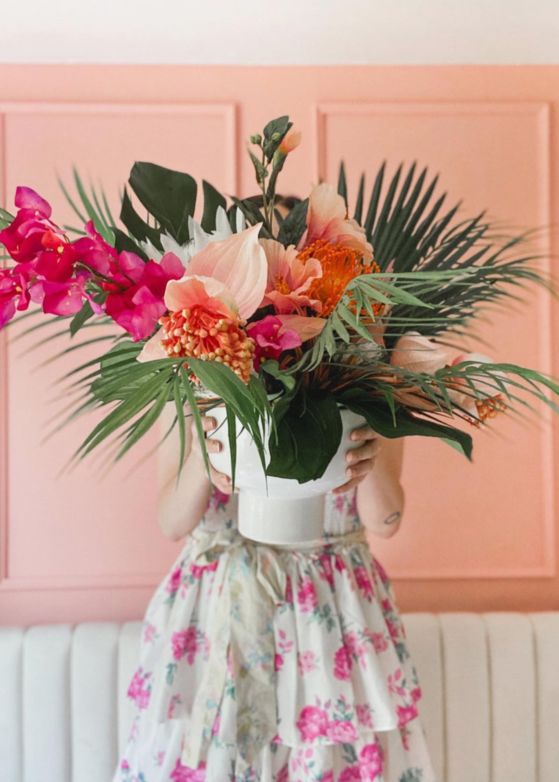 tropical flower arrangment with hibiscus, palms, bougainvillea, and monstera