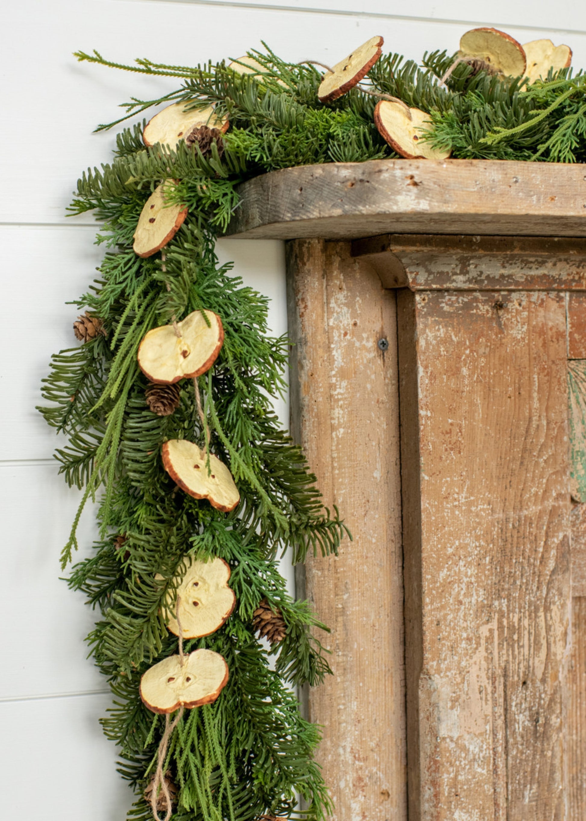 Decorative apple garland hanging on a mantel