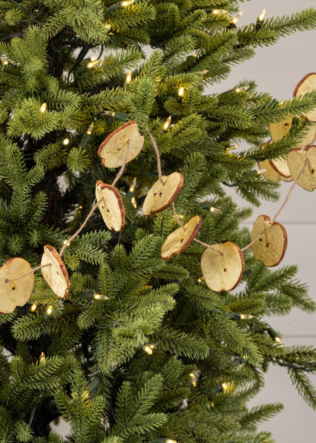 Decorative apple garland on a Christmas tree 