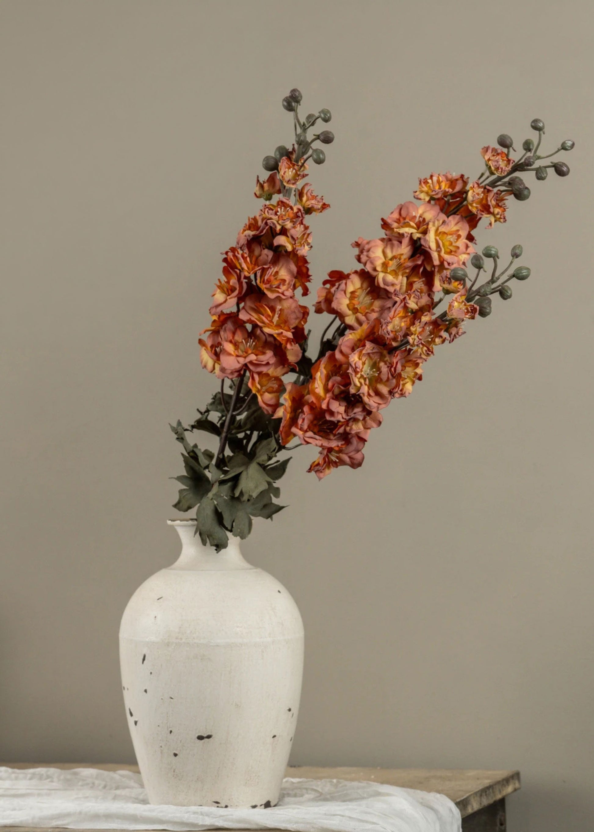 Arrangment of Dried Look Artificial Larkspur Flowers in a vase