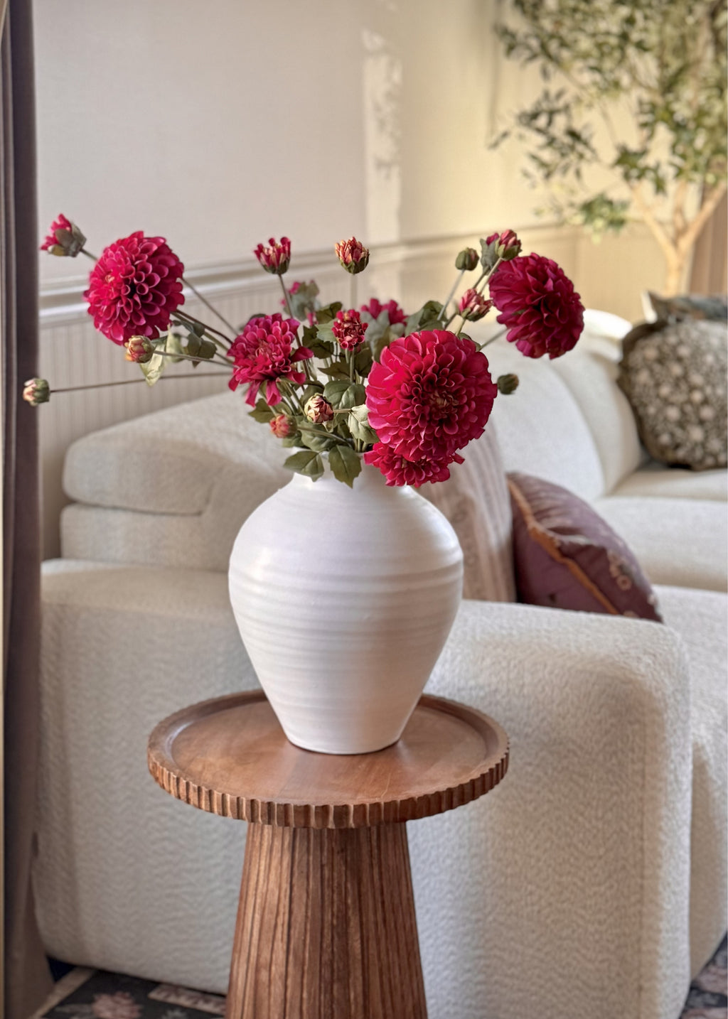 faux zinneas in a white vase