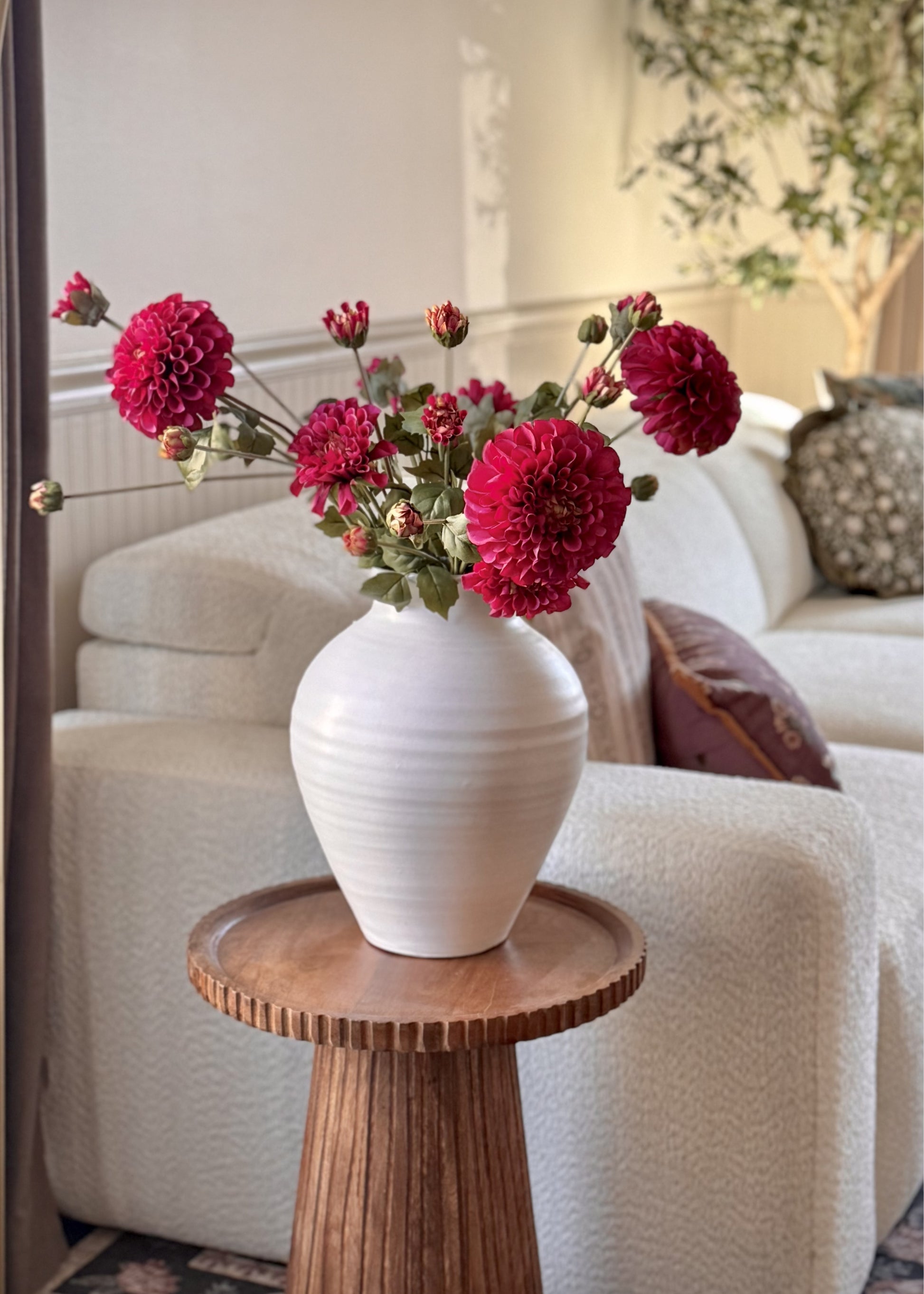 faux zinneas in a white vase