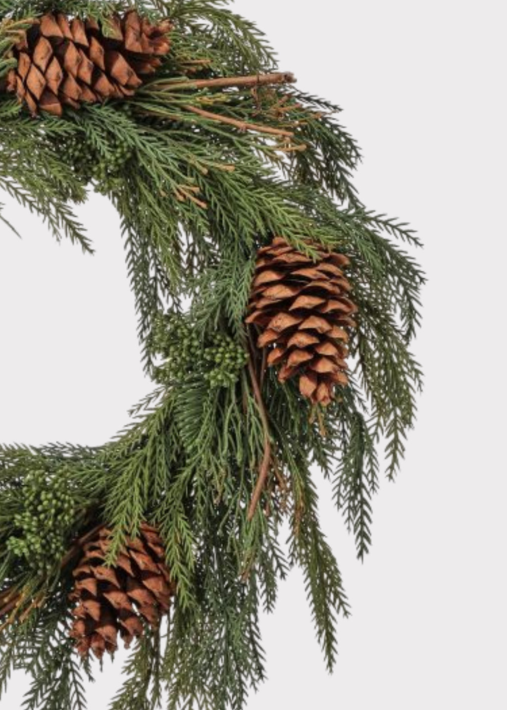 Close-up of a Fake Winter Evergreen Wreath with Pine Cones