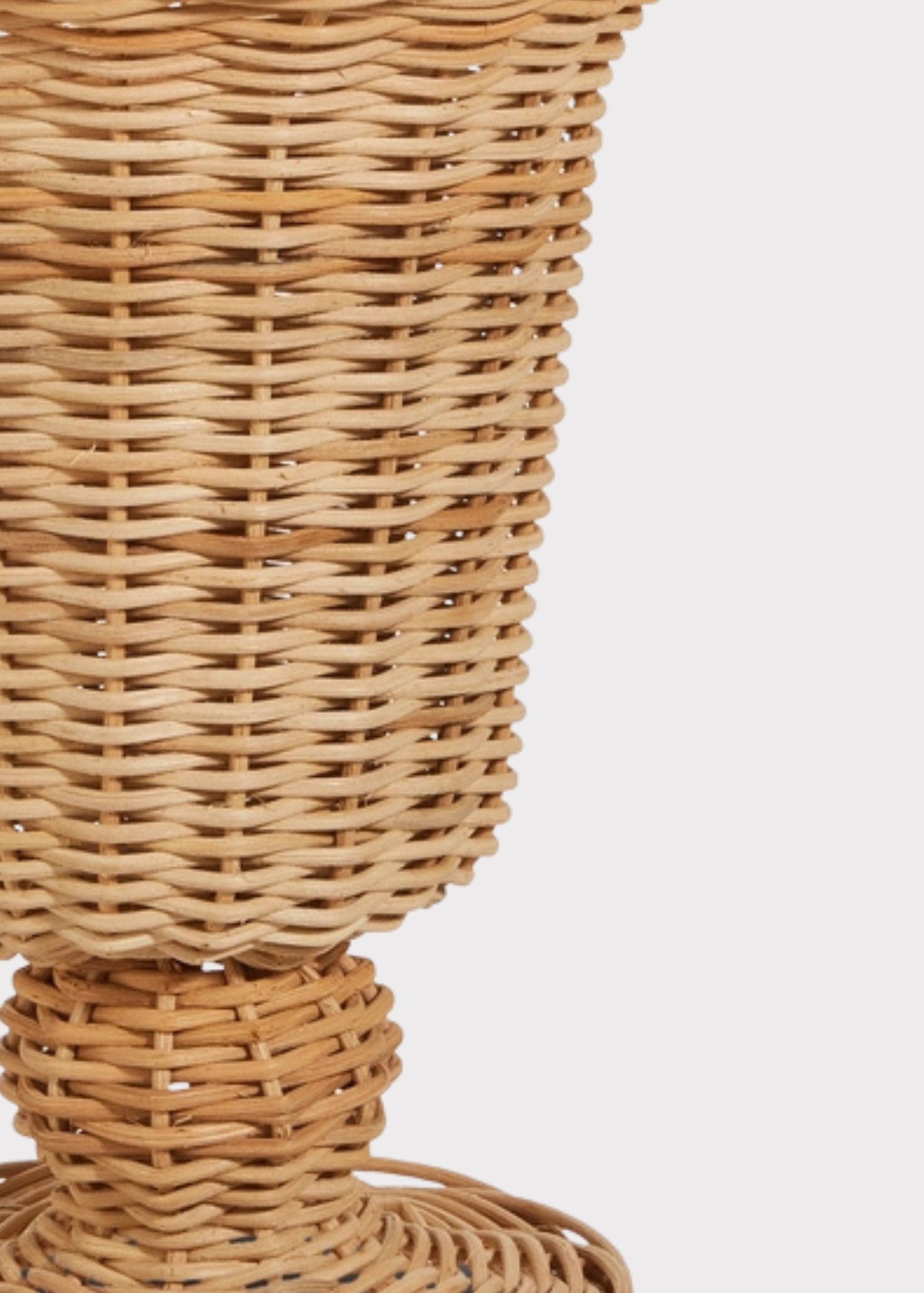 Close-up of a Woven Wicker Footed Urn Vase
