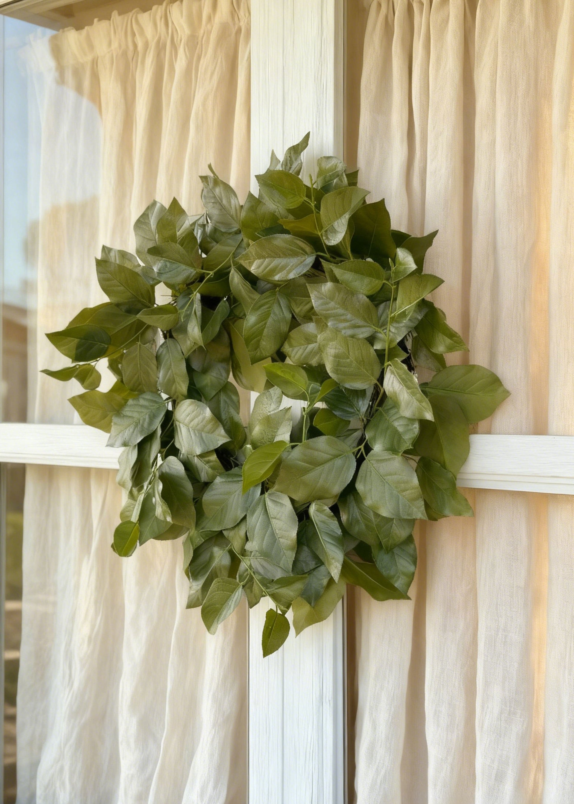 salal wreath hanging from a window