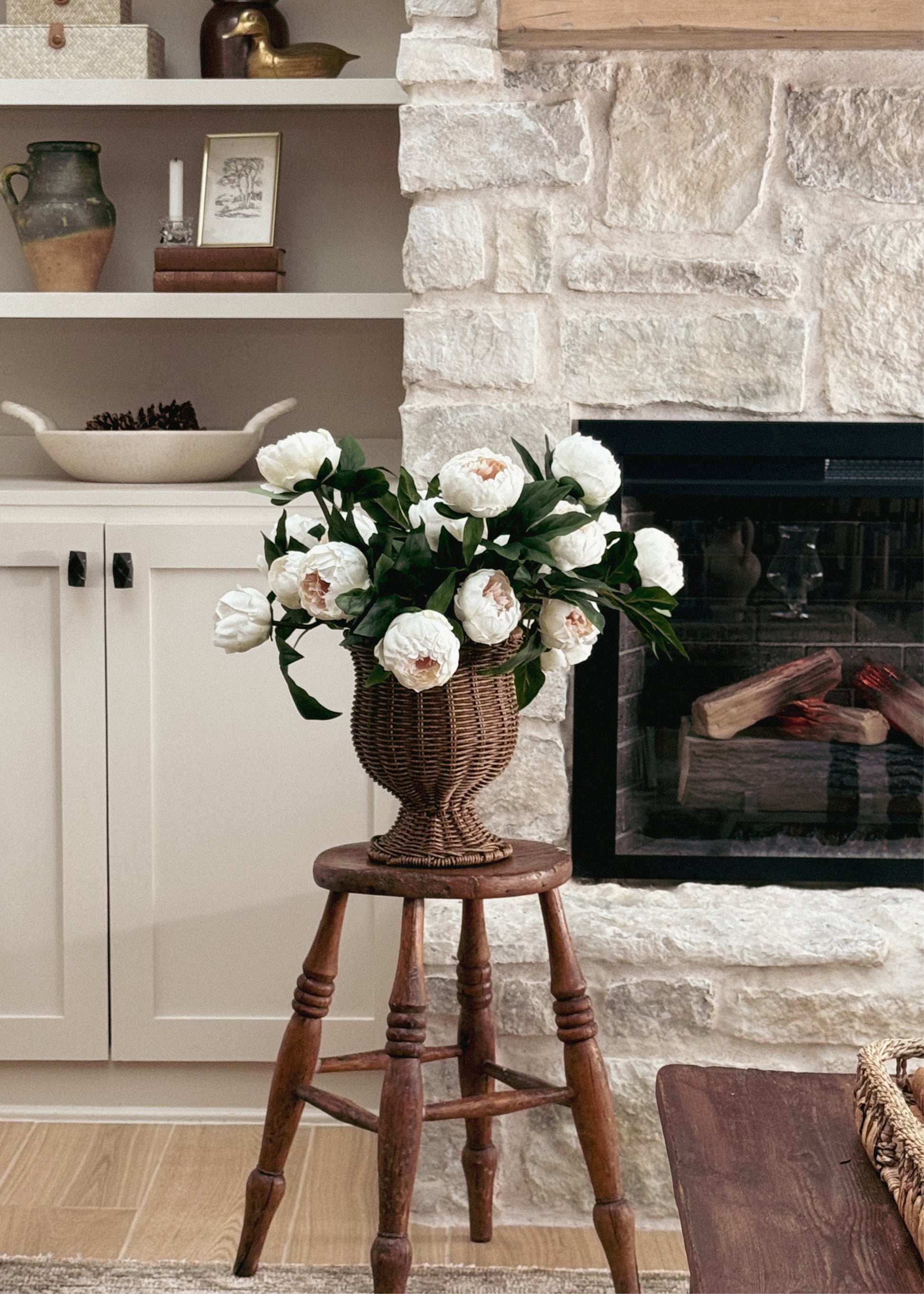 Cream faux peonies in a wicker vase