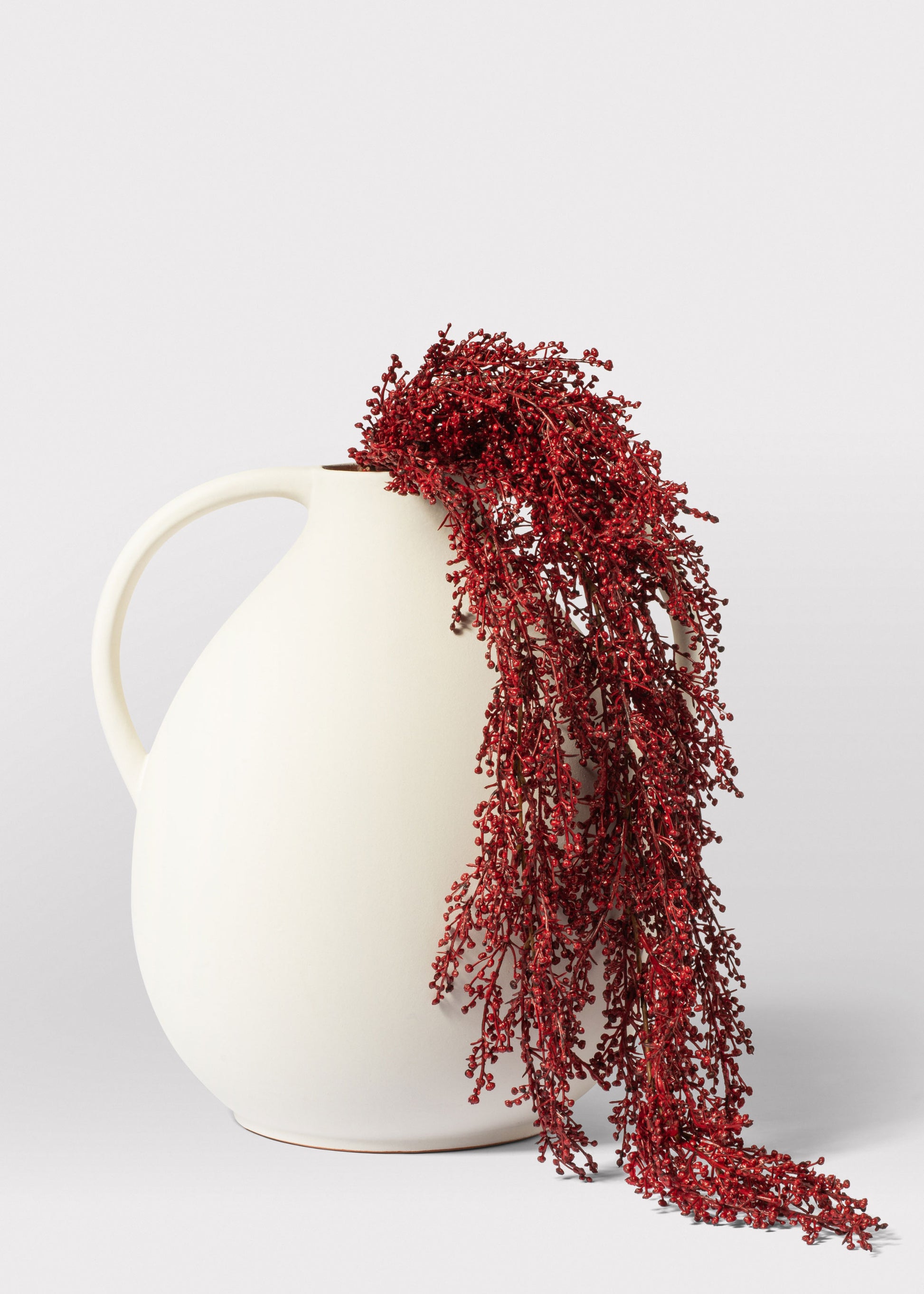 Burgundy Fake Sedum Draped Over Jug Vase