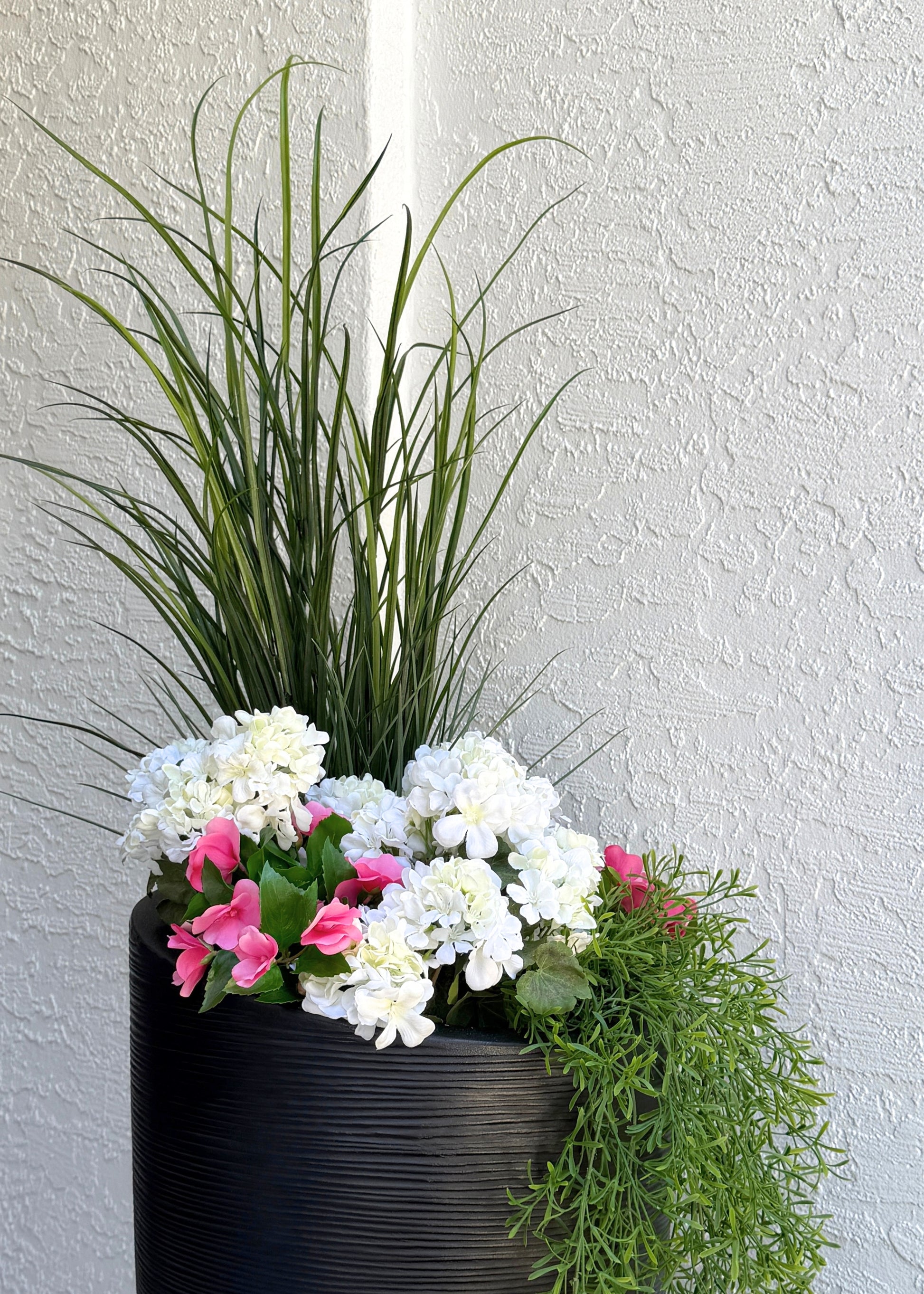 artificial grass bush with geraniums and impatiens