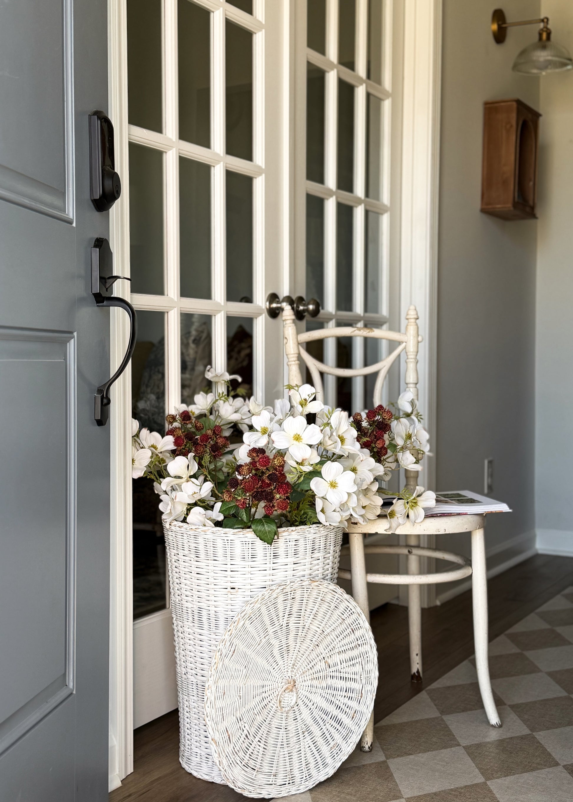 Decorative arrangment of white dogwood flowers and raspberry branches