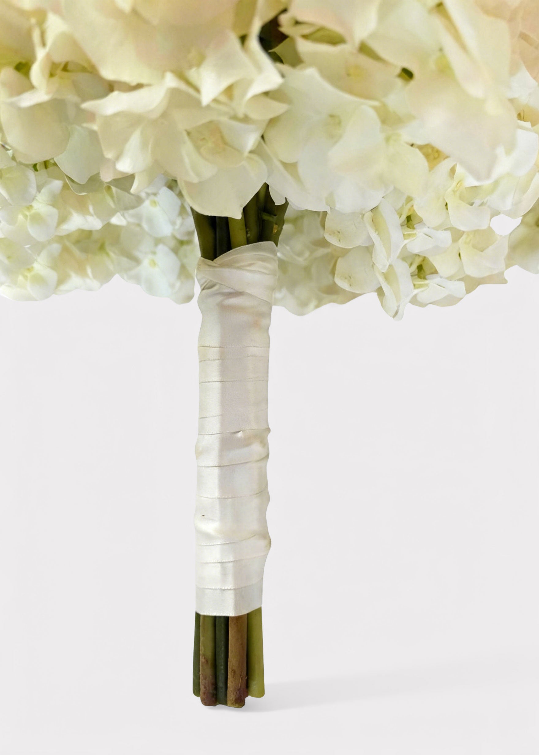 Bouquet of white flowers with ribbon wrapped stems
