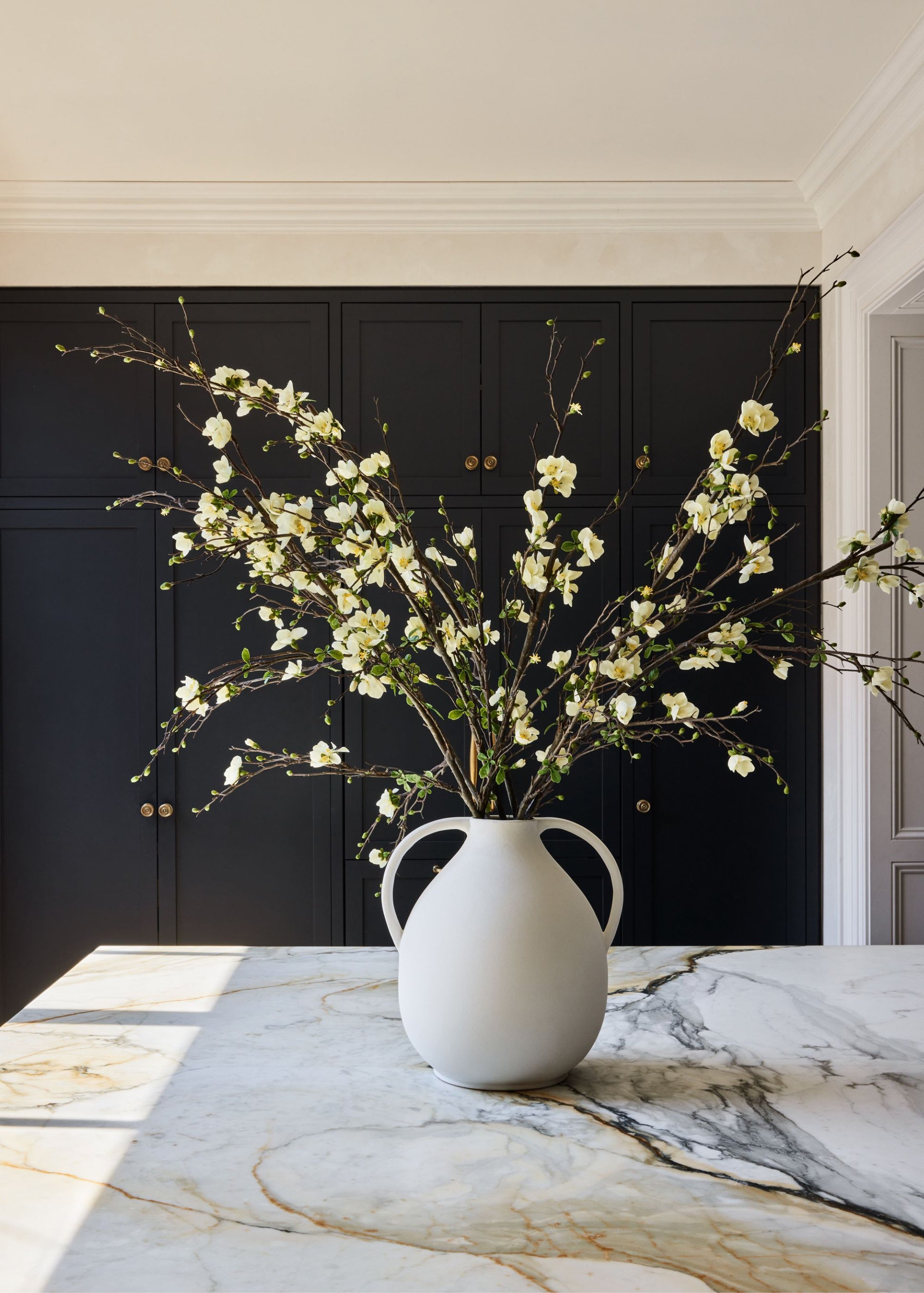 Cream Artificial Budding Blossom Branch in White Jug Vase