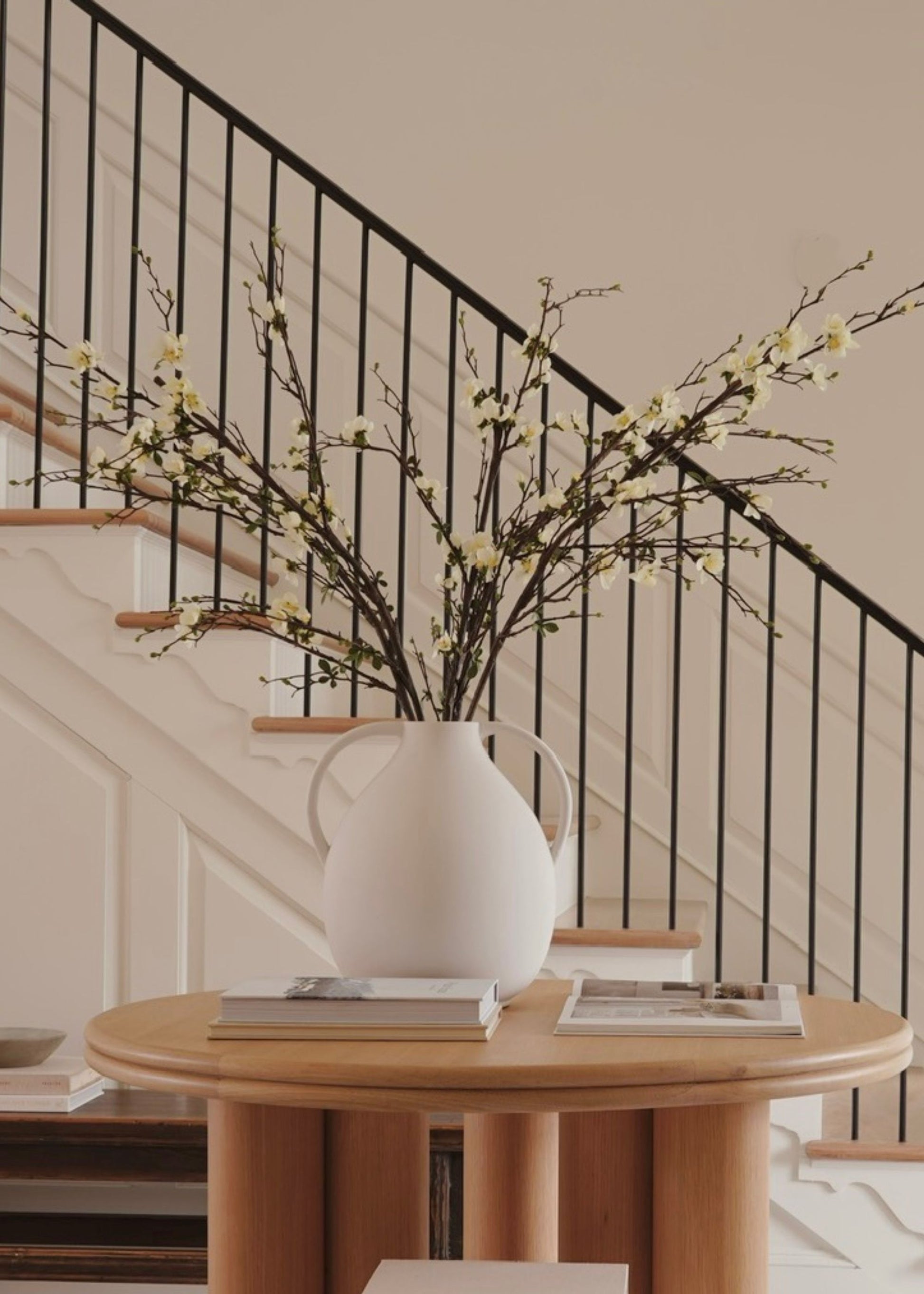 White vase with faux blossom branches 